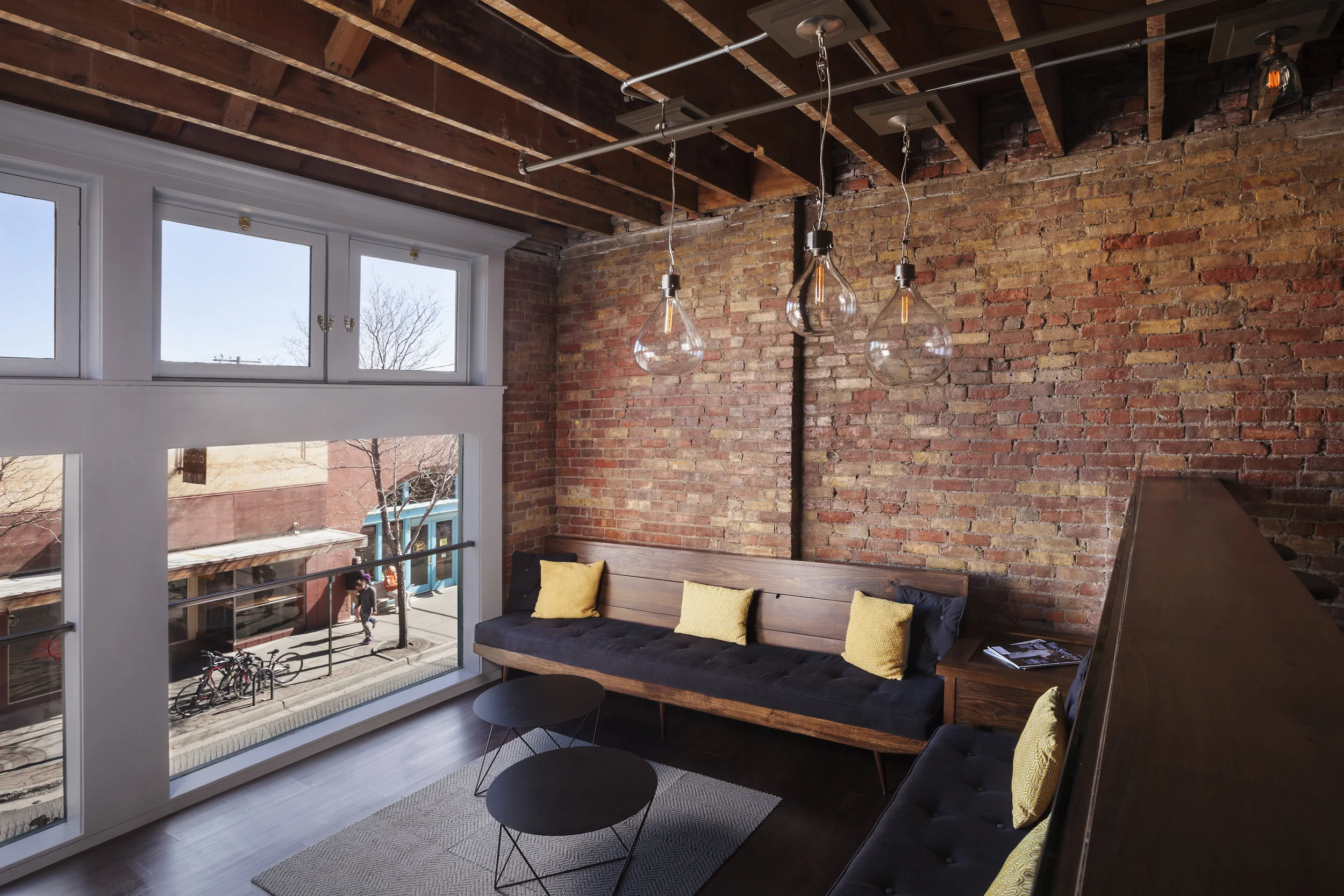 Crown moulding frames the view out of the picture windows in this cool lounge space. 