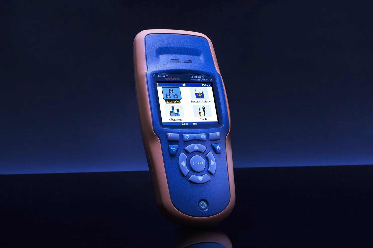A handheld electronic device with a blue and orange casing is shown against a dark background. The screen displays various menu options, including settings and tools. The device features several navigation buttons and a "SELECT" button.