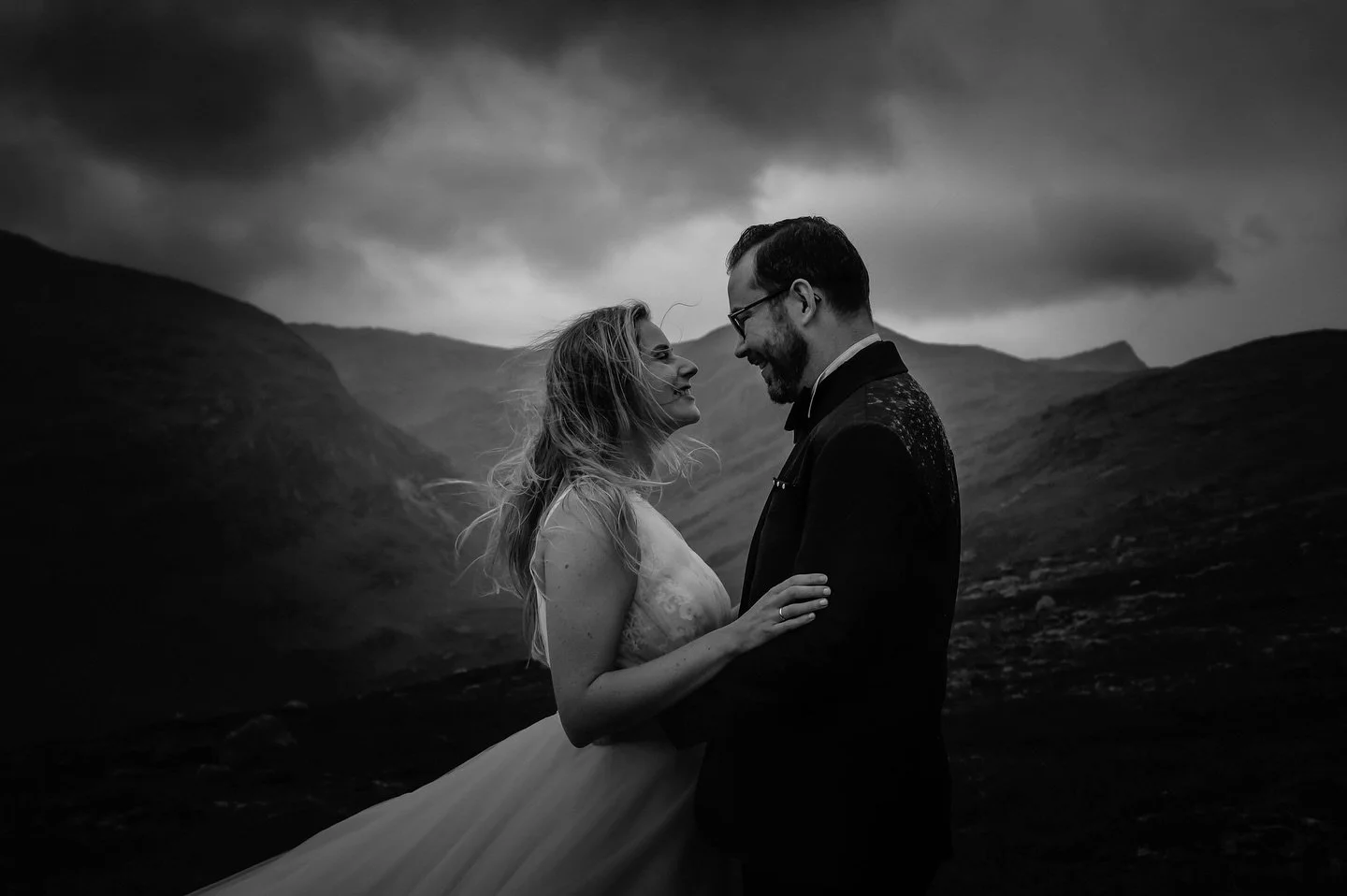 Sometimes, a black and white image is what it takes to tell the whole story.
I love the raindrops reflecting the light on Steffen&rsquo;s shoulders, protecting his bride from the cold rain. And Camilla&rsquo;s radiant smile that shines through the st