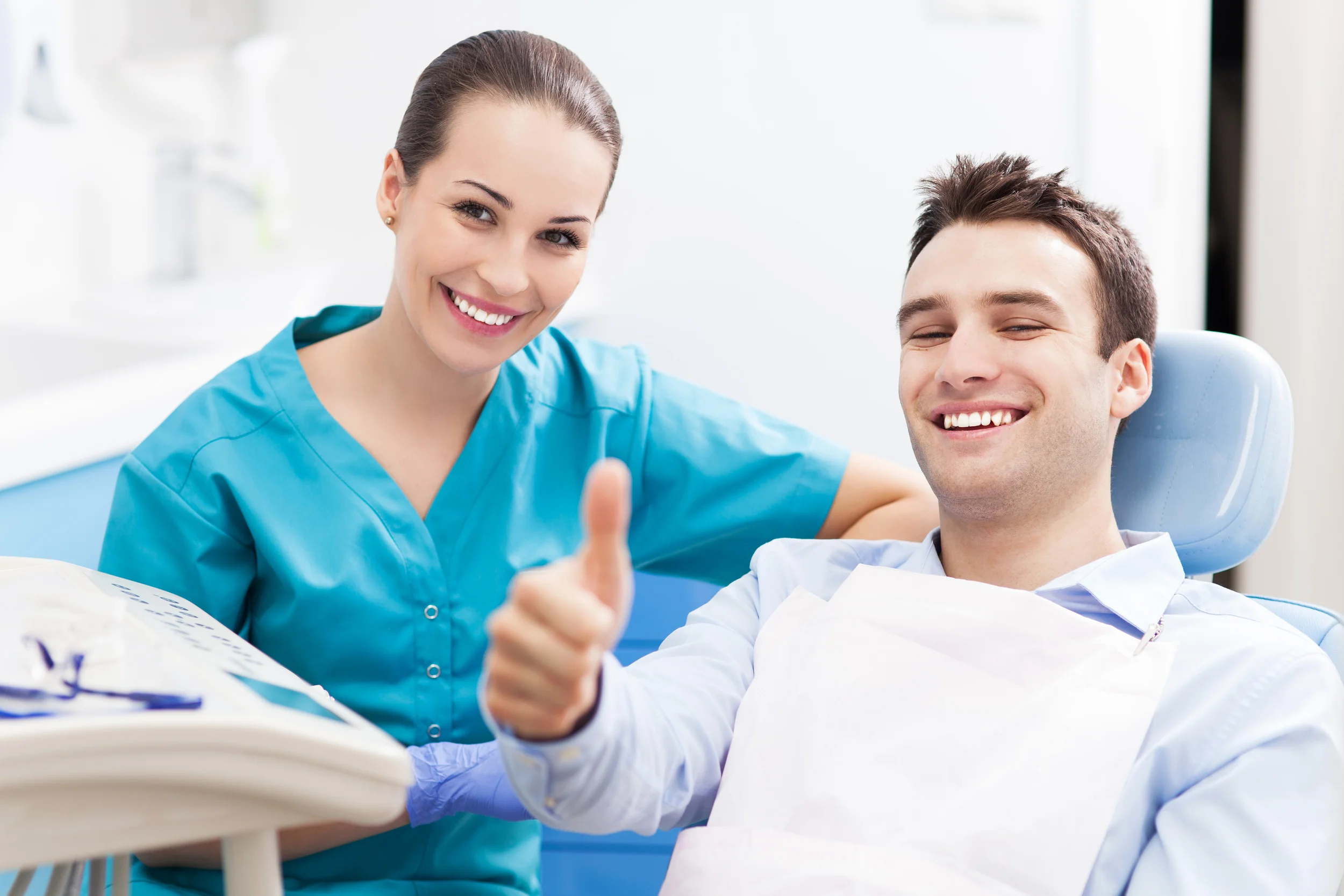 bigstock-Man-giving-thumbs-up-at-dentis-58722806.jpg