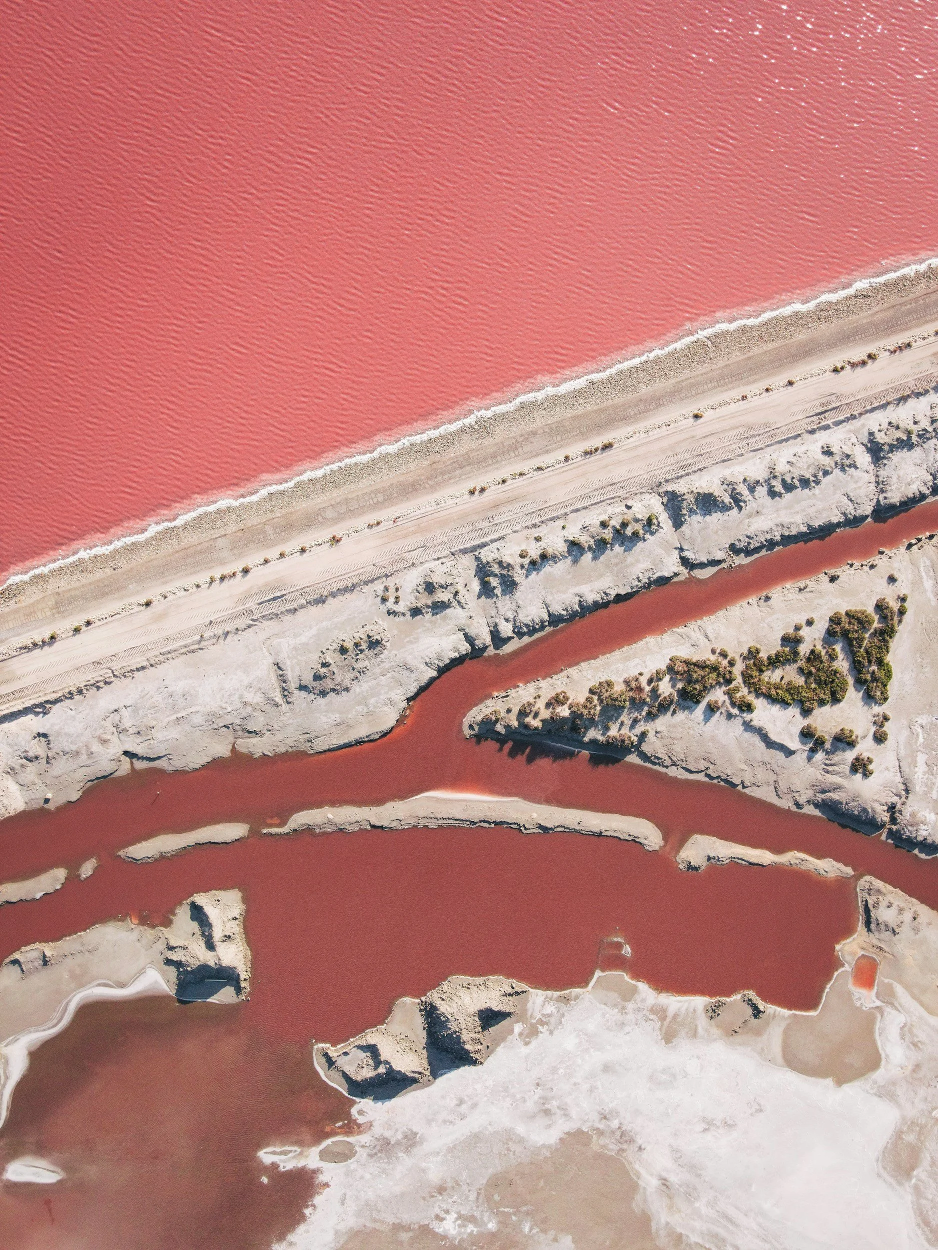 An abstract bird's-eye-view of the pink salt lagoon of the Camargue