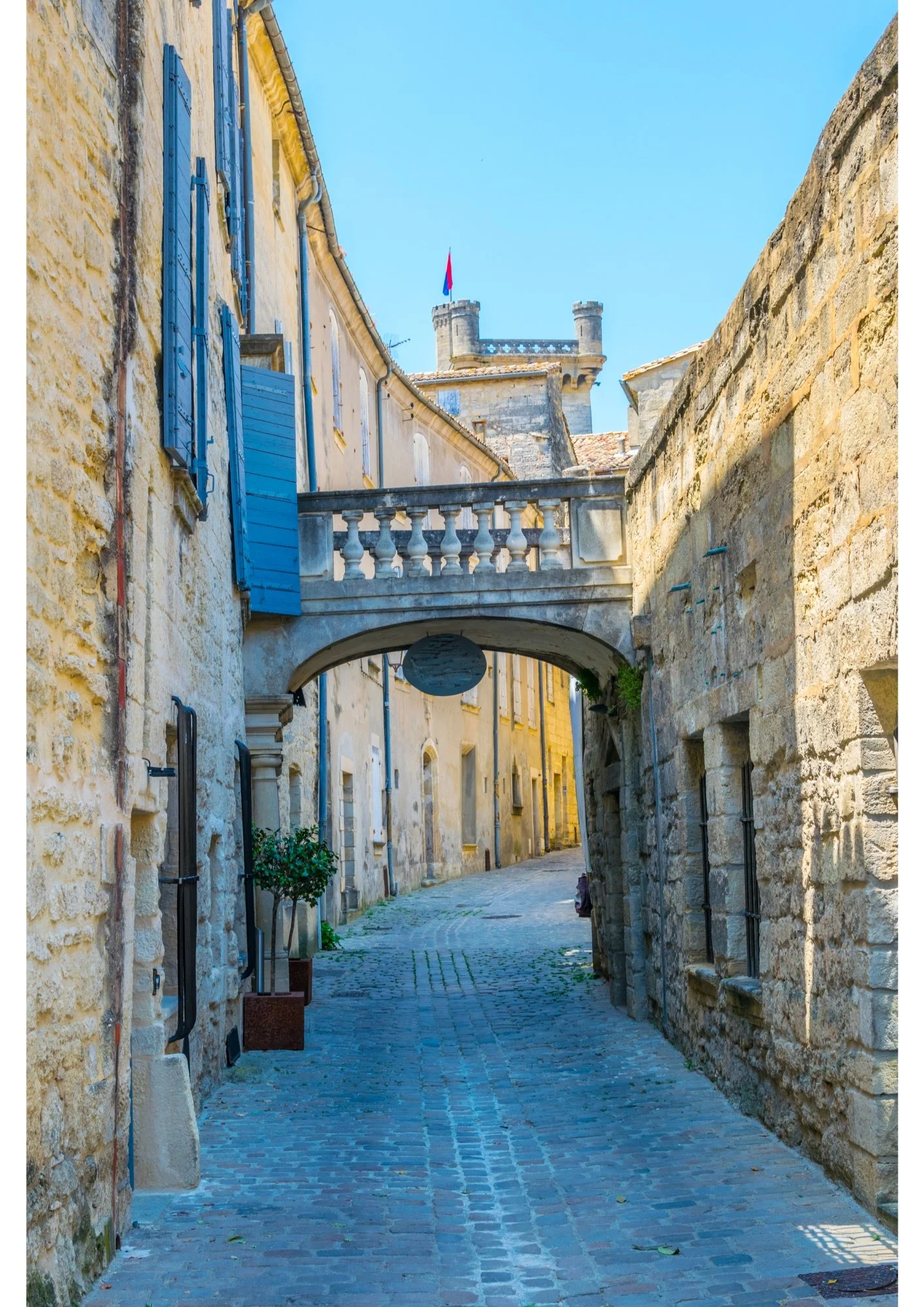 A medievil passageway in Uzès with Duchy tower in the distance