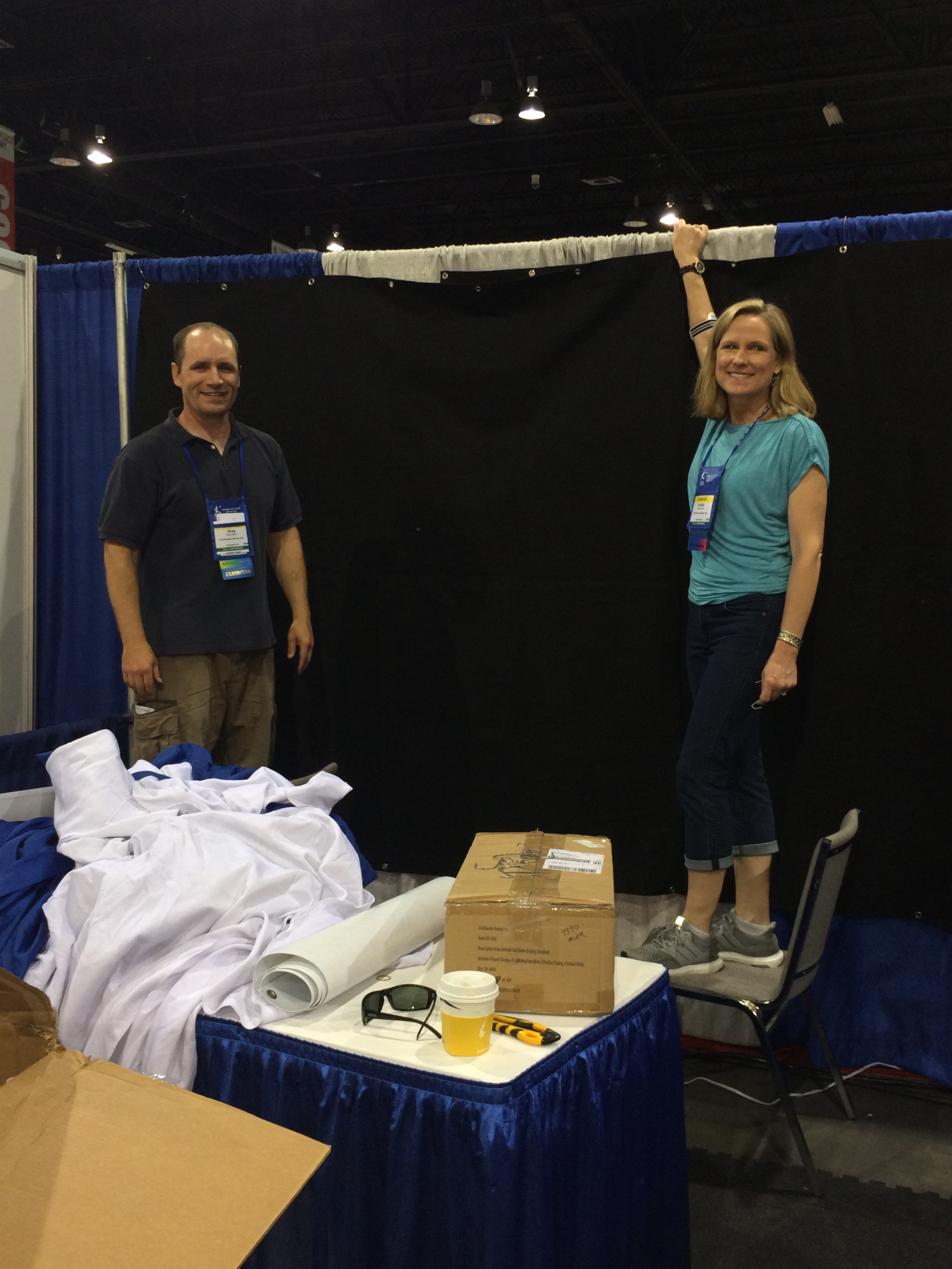 Kristin Miller Burrell and Greg Hughes setting up Continuum Games booth at ASTRA