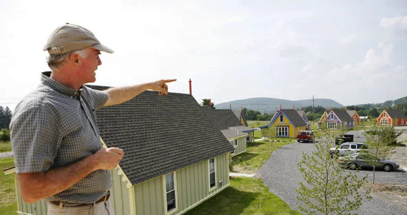 Bruno Schickel pointing to his favorite trio of cottages.