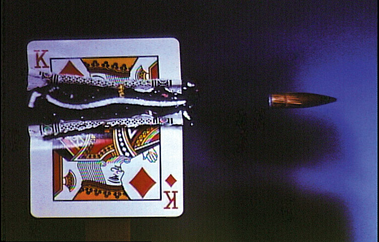  As it rips the card in half, the rotating bullet carves out a spiral shaped slice of card. 