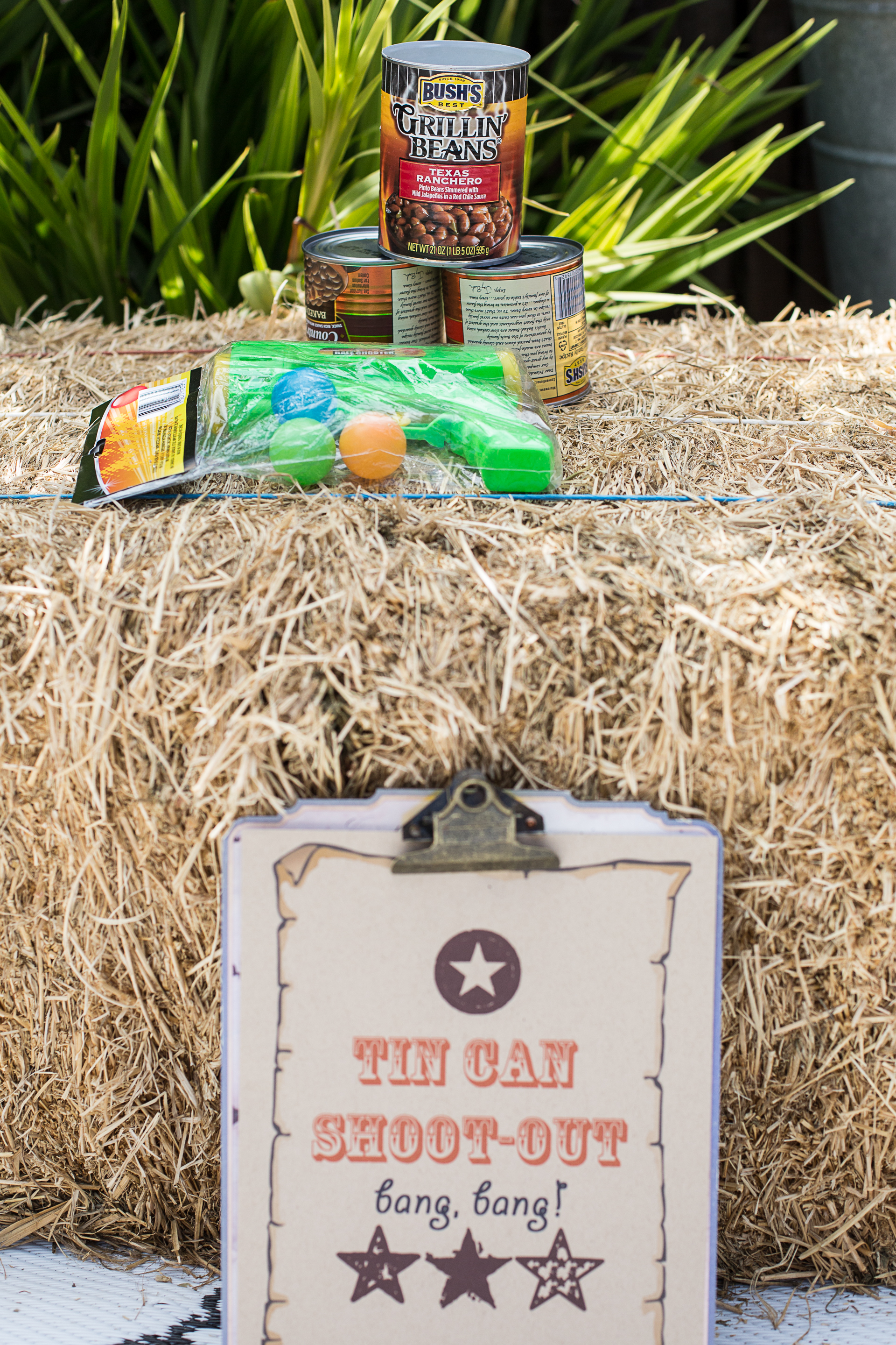  Tin Can Shoot-Out. A great way to reuse those cans from the Cowboy Beans!&nbsp; I found the gun at the Dollar Store, but it didn't have the "oomph" necessary to shoot from a gaming distance.&nbsp; Next time, I would splurge for a Nerf gun. 