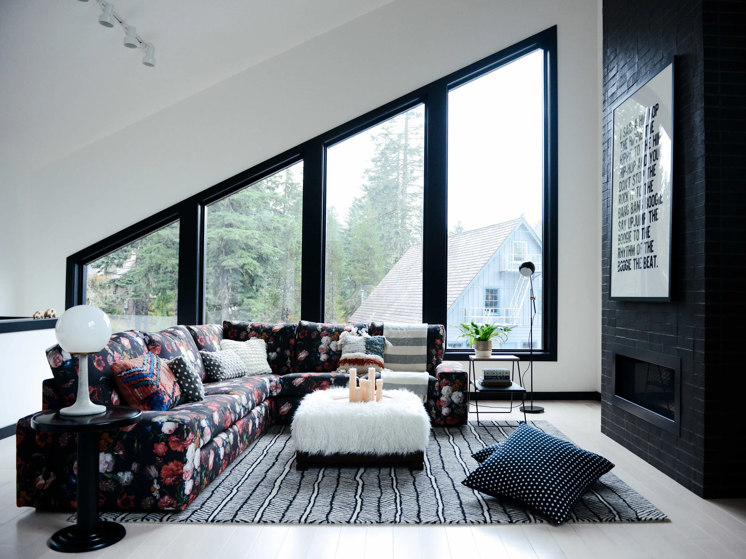 Above: To balance the stoic fireplace we brought in a mega sectional and covered it with a custom designed fabric. A shearling ottoman ties it all together and brings in those cabin vibes. Side tables, table and floor lamp and floor pillows are from Schoolhouse Electric .