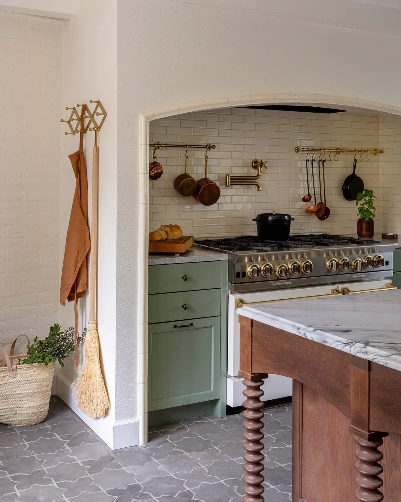 Period-inspired kitchen design with modern functionality includes a custom hood surround and Blue Star range