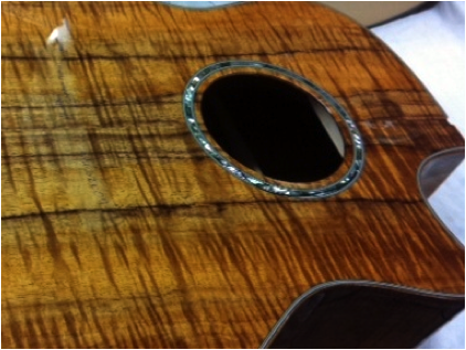 Guitar: white wood, sealer coat, between coat and finish sanded guitar boy (UV urethane finish)