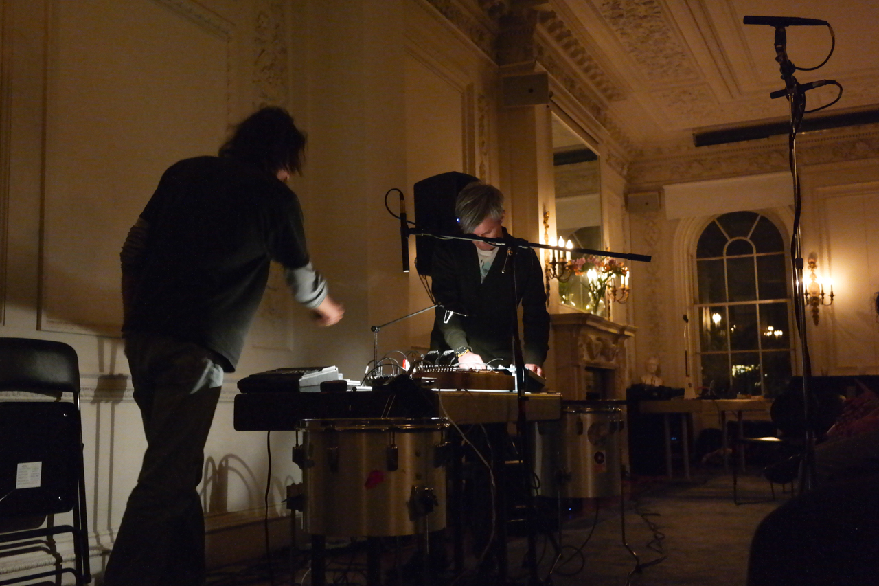 Tim Barnes + Jeph Jerman JEPH JERMAN : I grew up in a military family, so we moved around a lot, a different place every two years until my father retired in Colorado. I started playing music in a number of bar bands, whilst also experimenting with other forms – playing around with tape recorders and trying to find people to improvise with. Formed a few long lasting bands (Big Joey, City Of Worms, Blowhole) and began recording and playing solo as hands to. Ran a cassette label during the 80s cassette culture explosion. Eventually ended up in Seattle, where I fell in with the local musical community. Two years of near-constant playing with people like Paul Hoskin, Doug Theriault, Dave Knott, Angelina Baldoz, Lori Goldston, Mike Shannon and Wally Shoup. One memorable concert with John Butcher. Continued to develop my solo work, and began improvising with natural sound makers (stones, shells, pine cones) around 1996. Formed the first animist orchestra in 1999, to perform works for same. Moved to Arizona and have since done tours with Tim Barnes, Sean Meehan and David Daniell, Paul Hoskin, and toured Australia and New Zealand with Greg Davis. In 2001 I made recordings of the desert and it’s interaction with man made structures and released a new cassette every month for a year. I continue to investigate the desert, build crude sound making devices and play and record whenever the opportunity arises. TIM BARNES is a globally recognized percussionist, composer, sound designer, and audio archivist. He has performed at the Guggenheim, Whitney, and Pompidou museums, as well as in galleries and performance halls in Tokyo, Berlin, Rome, Belgium, Stockholm, Mexico City, and Melbourne. He has been recruited to perform with some of experimental music’s most accomplished players, including John Zorn, Kim Gordon, Ikue Mori, Jim O’Rourke, Lee Ranaldo, and Jeph Jerman. American corporations such as Starbucks, Nike, Cadillac, and Merrill Lynch have hired Tim to create sound collages for their television advertisements. He has also worked closely with Fluxus artists La Monte Young and Henry Flynt with archival restoration of recorded works, and in 2005, Tim performed and recorded Alison Knowles’ composition “Onion Skin Song”. Currently, he is working with Vito Acconci and the publisher Primary Information on presenting Mr. Acconci’s complete recorded works. Tim lives in Louisville, Kentucky, where he is the Artistic Director of the performing and visual art space Dreamland.