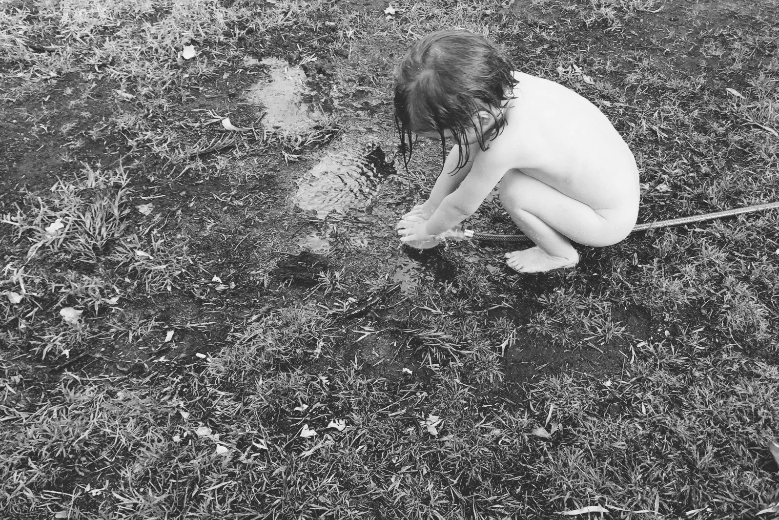 Here's my daughter playing with a hose on a hot, summer's day. Including the rest of the backyard in the photo would have been distracting - so I shot from above to keep the photo as simple as possible..