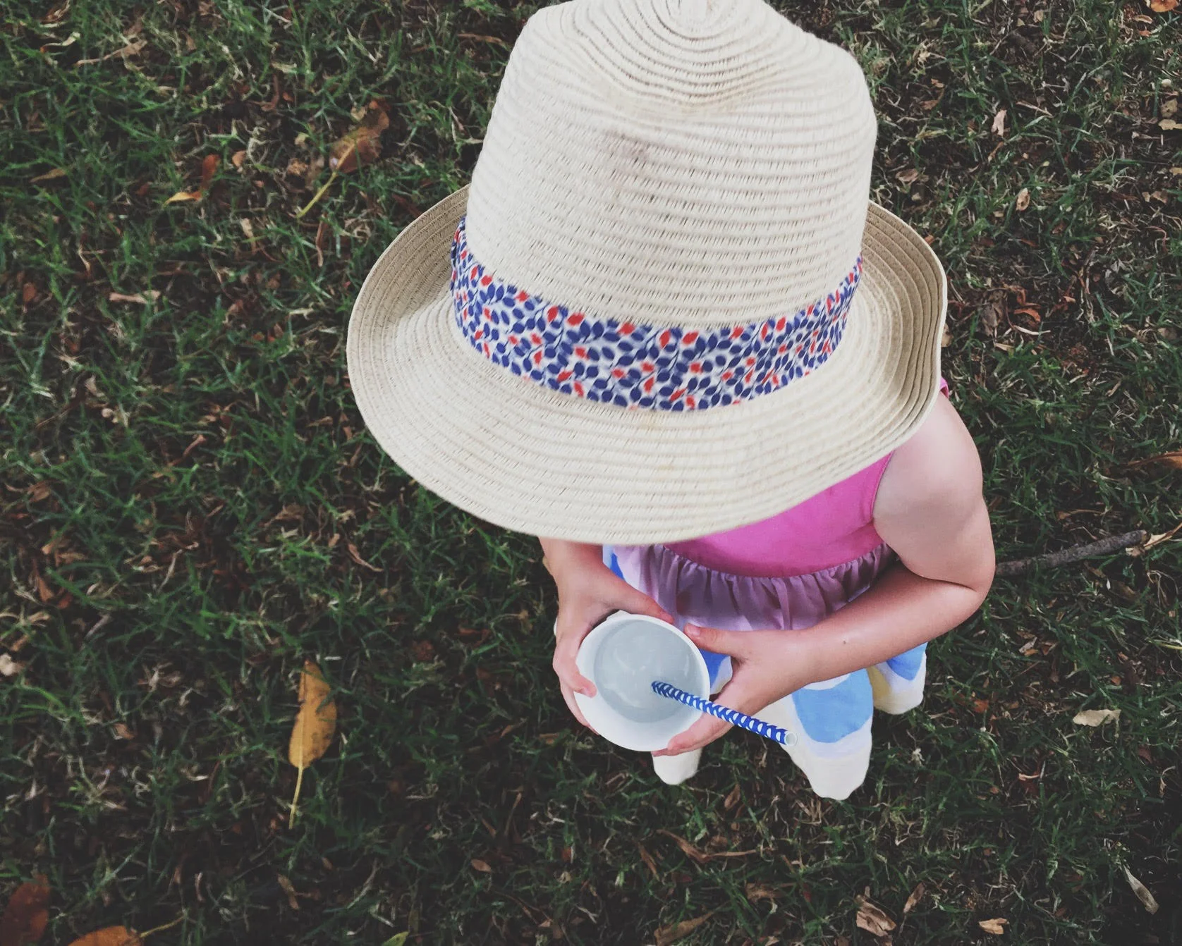In this photo, I choose to focus on the cup in my daughter's hands, rather than her hat.