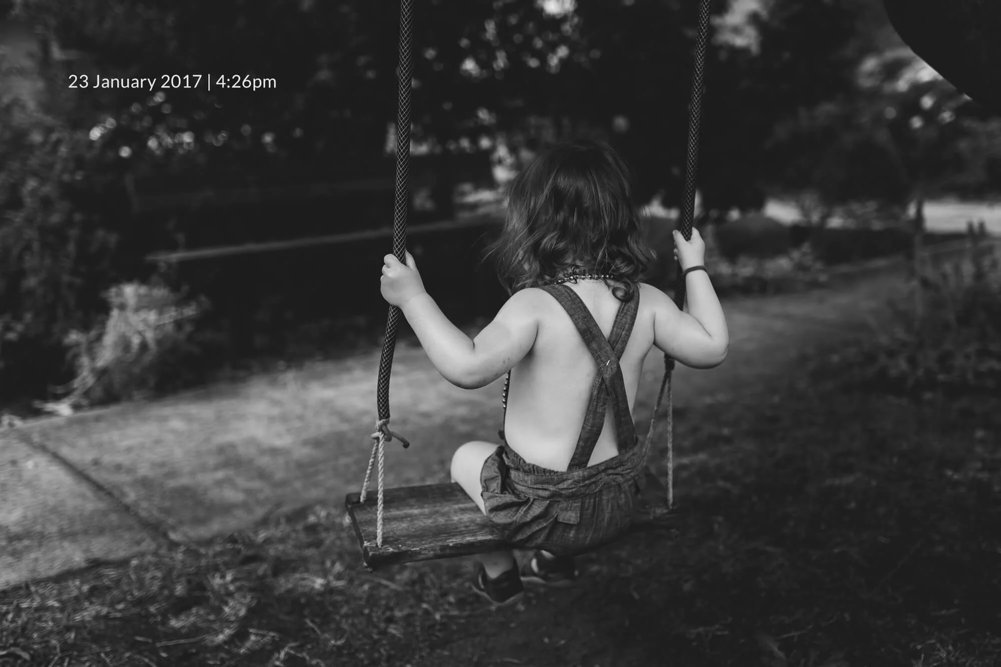 Melbourne family lifestyle photography. Portrait of a toddler on a swing.