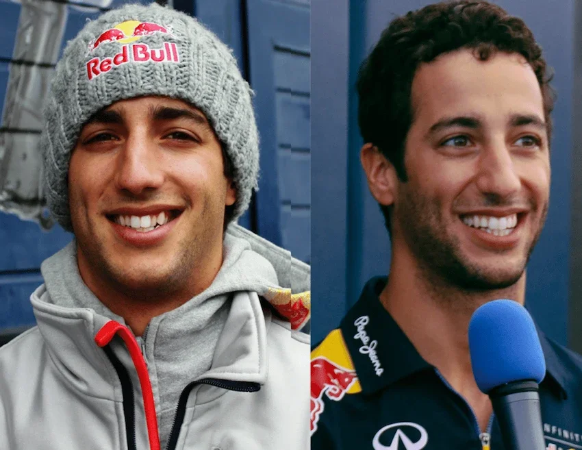 Two men smiling; one is wearing a Red Bull beanie and outdoor gear, the other is speaking into a microphone with a Red Bull logo on his shirt.
