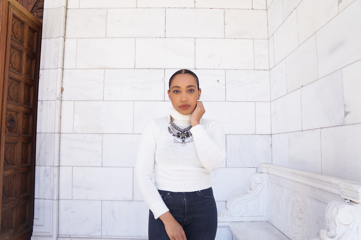 Andrea Fenise Memphis Fashion Blogger styles a white turtleneck and statement necklace