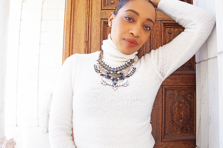 Andrea Fenise Memphis Fashion Blogger styles a white turtleneck and statement necklace