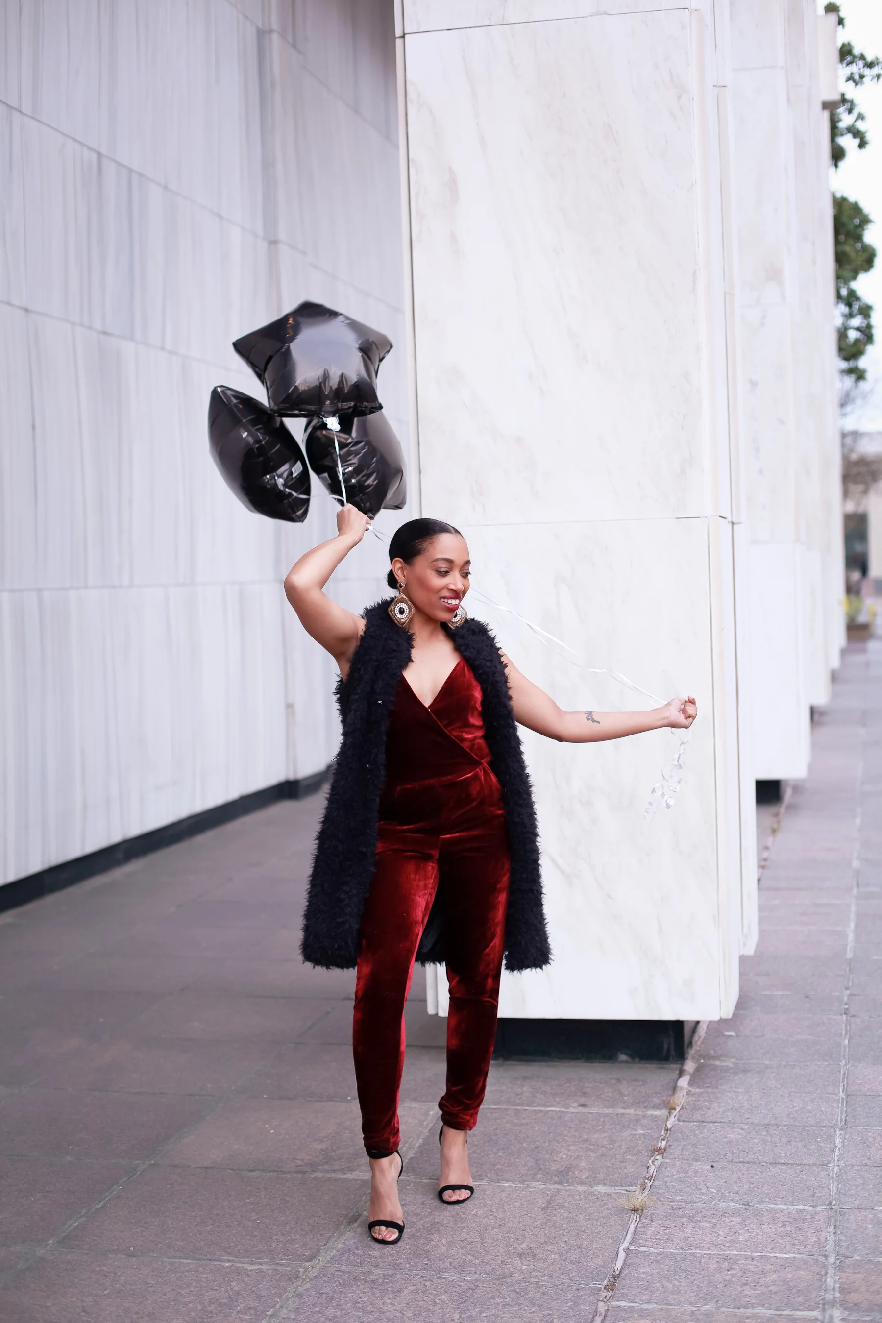 Andrea Fenise Memphis Fashion Blogger shares an outfit inspiration wearing a faux fur vest and velvet romper