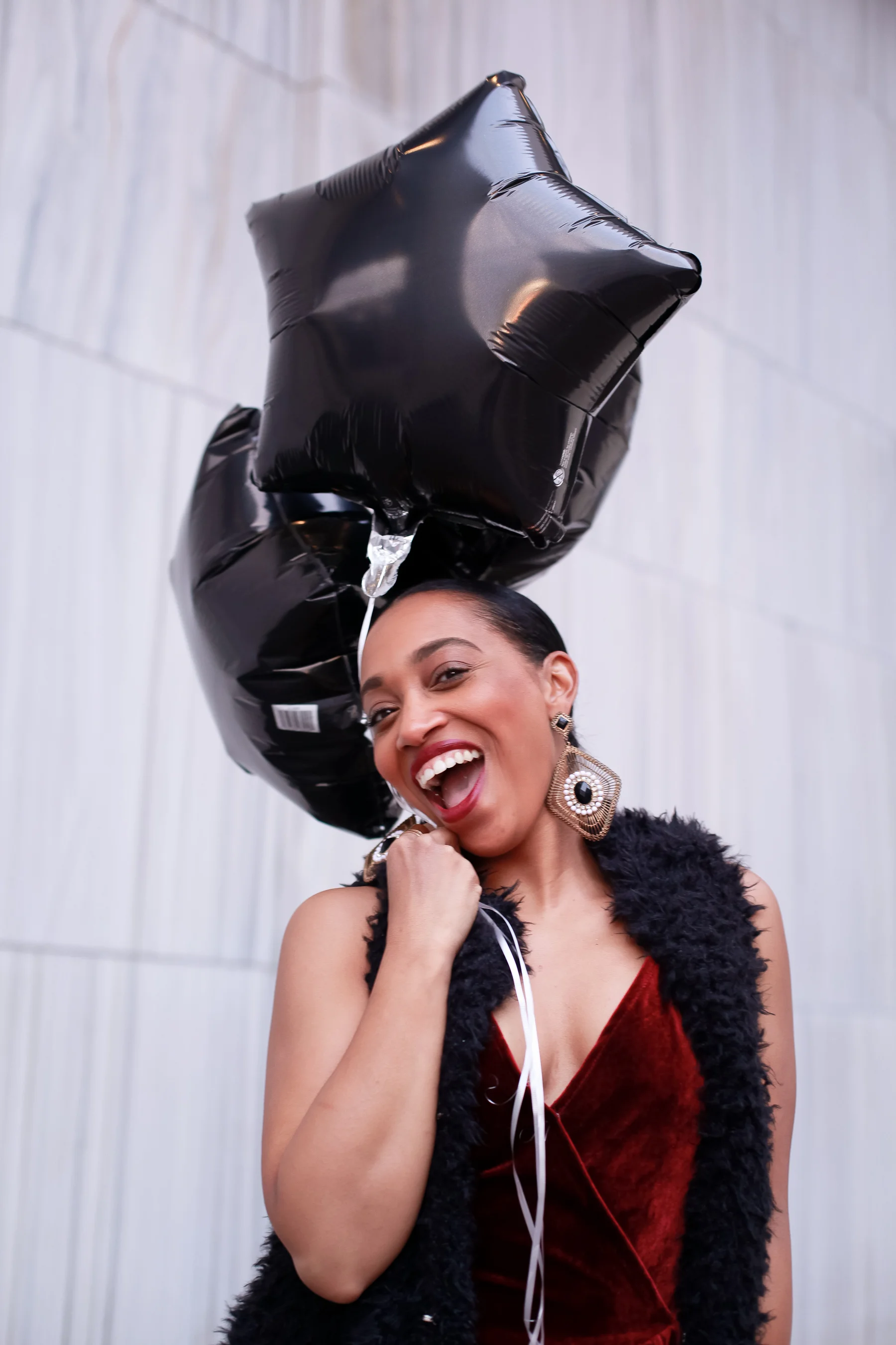 Andrea Fenise Memphis Fashion Blogger shares an outfit inspiration wearing a faux fur vest and velvet romper