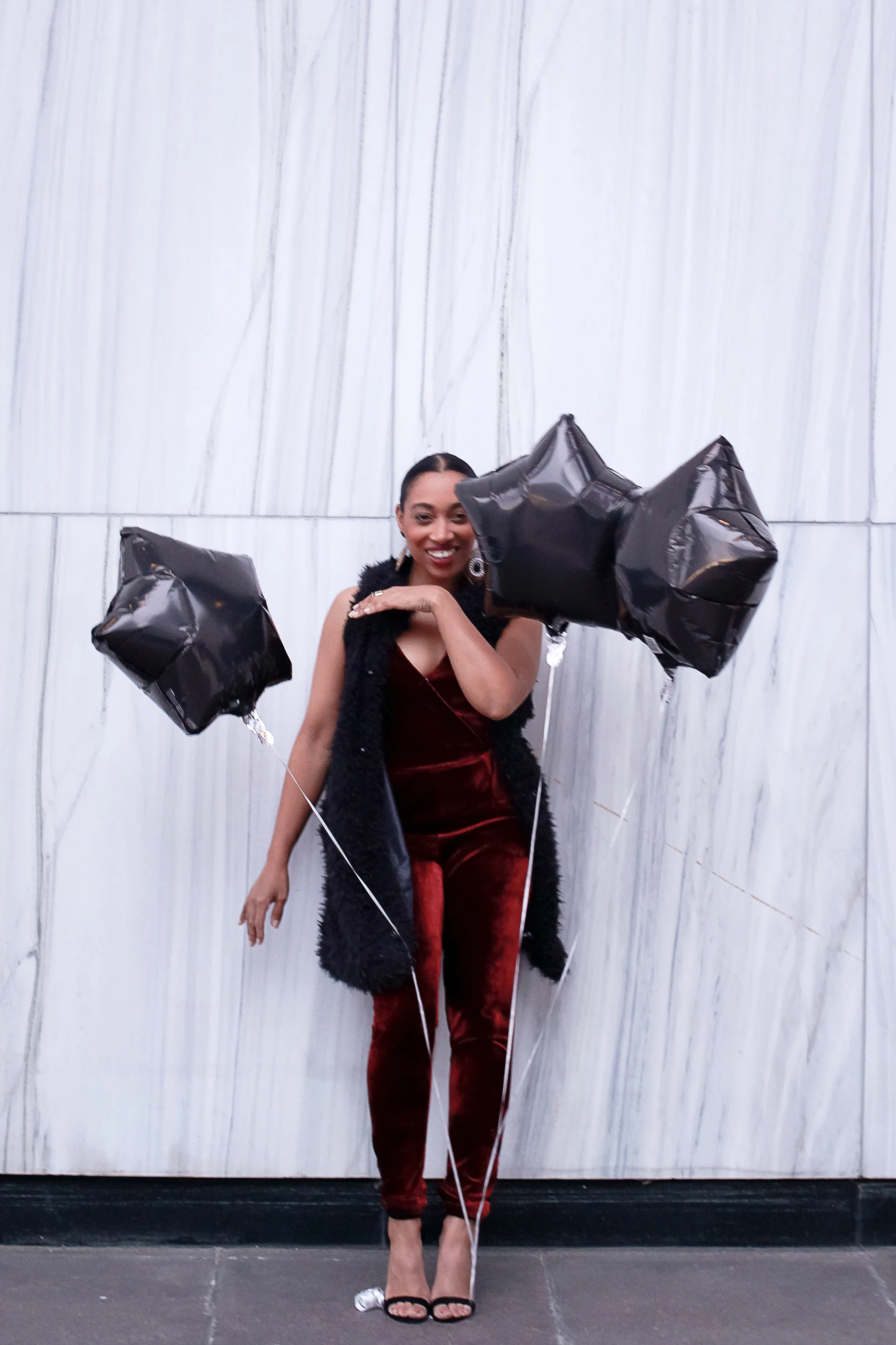 Andrea Fenise Memphis Fashion Blogger shares an outfit inspiration wearing a faux fur vest and velvet romper