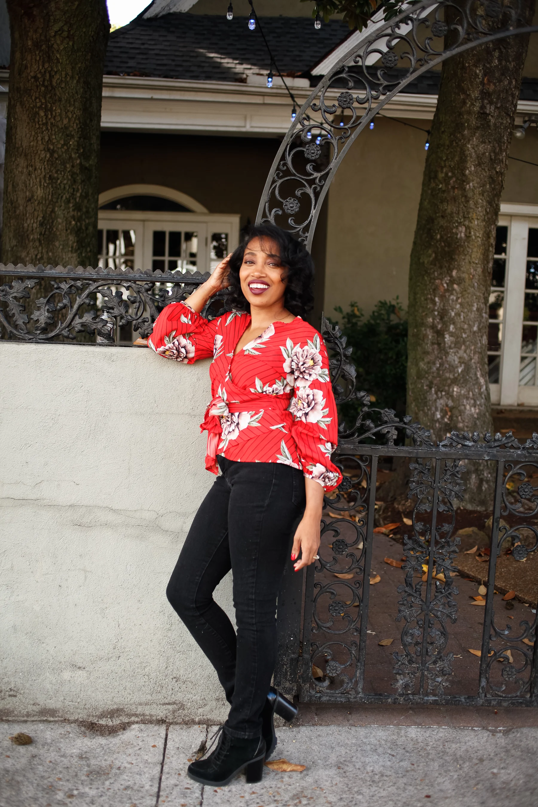 Andrea Fenise Memphis Fashion Blogger shares outfit post on red blouse and black denim
