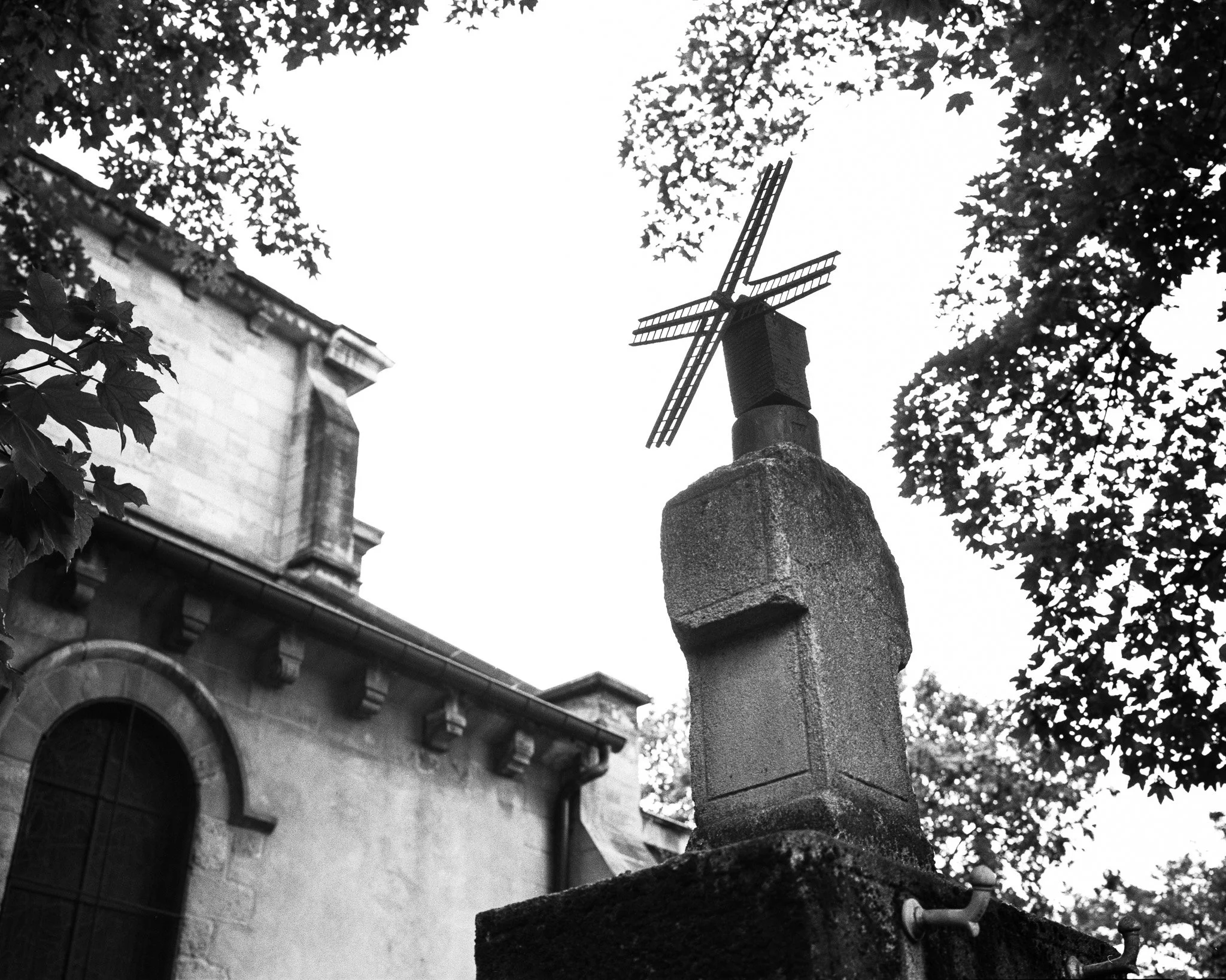 Black-and-white photograph of a street scene of a windmill, Paris.
