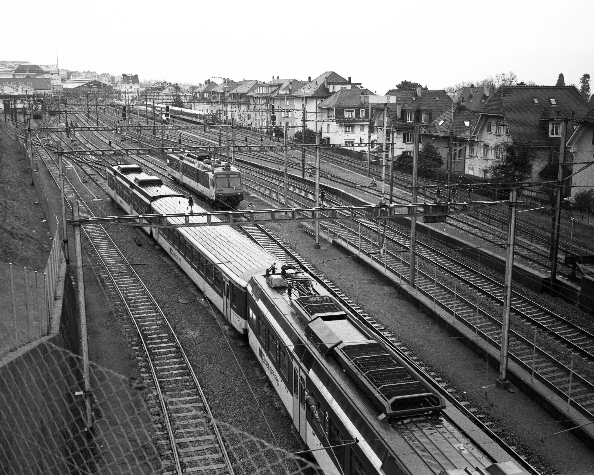 Black-and-white street photograph of a railroad yard, Lausanne.