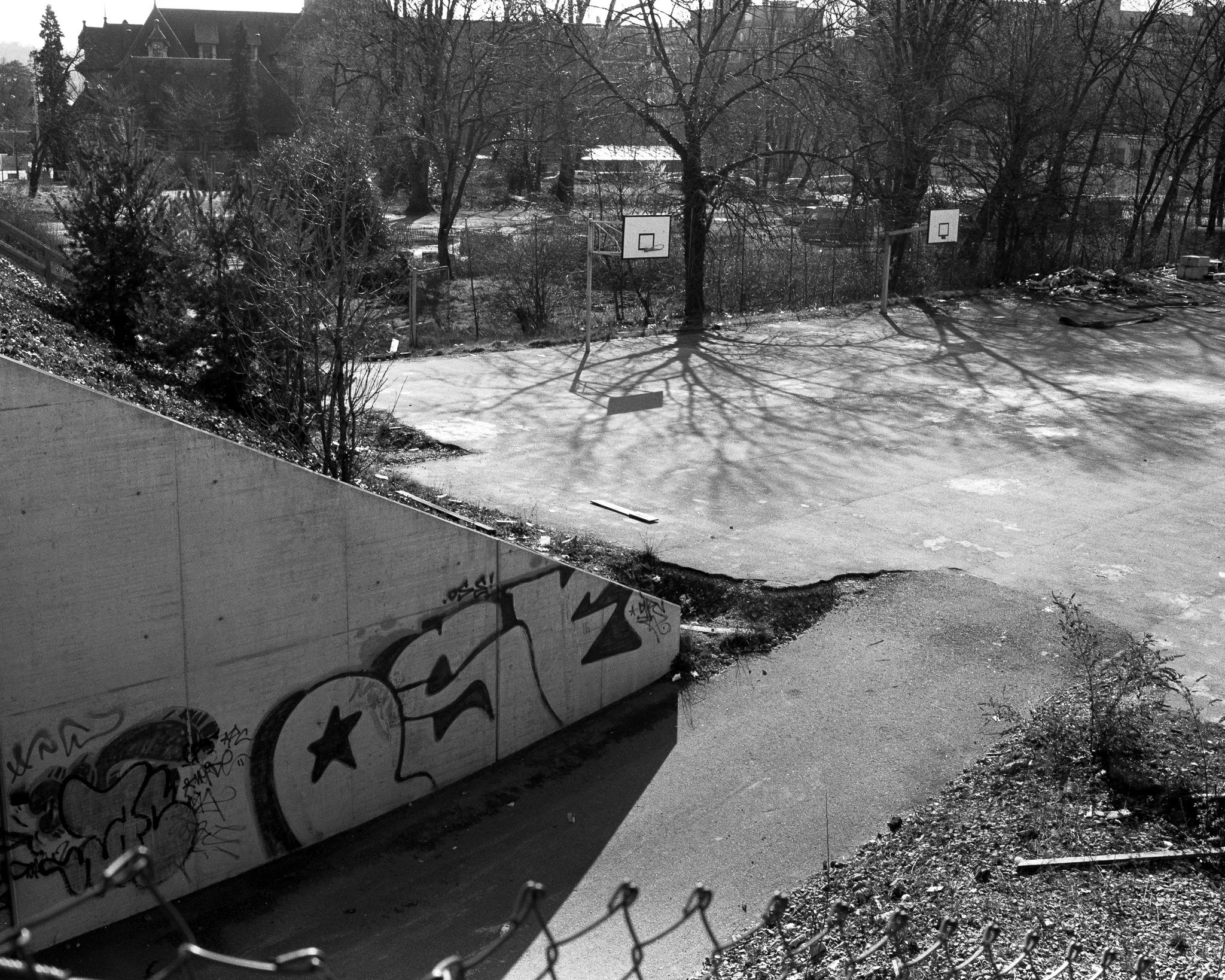 Black-and-white street photograph showing basketball courts, Lausanne.