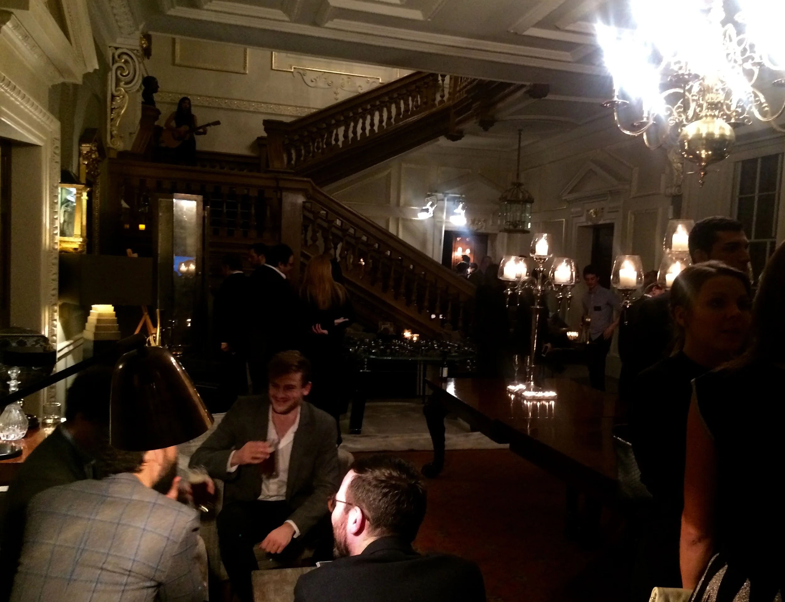Guests enjoy live guitar and whiskey tasting