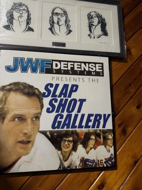 Pen and ink Hanson Brothers artwork displayed in the Slap Shot Gallery inside First Summit Arena in Johnstown, Pennsylvania