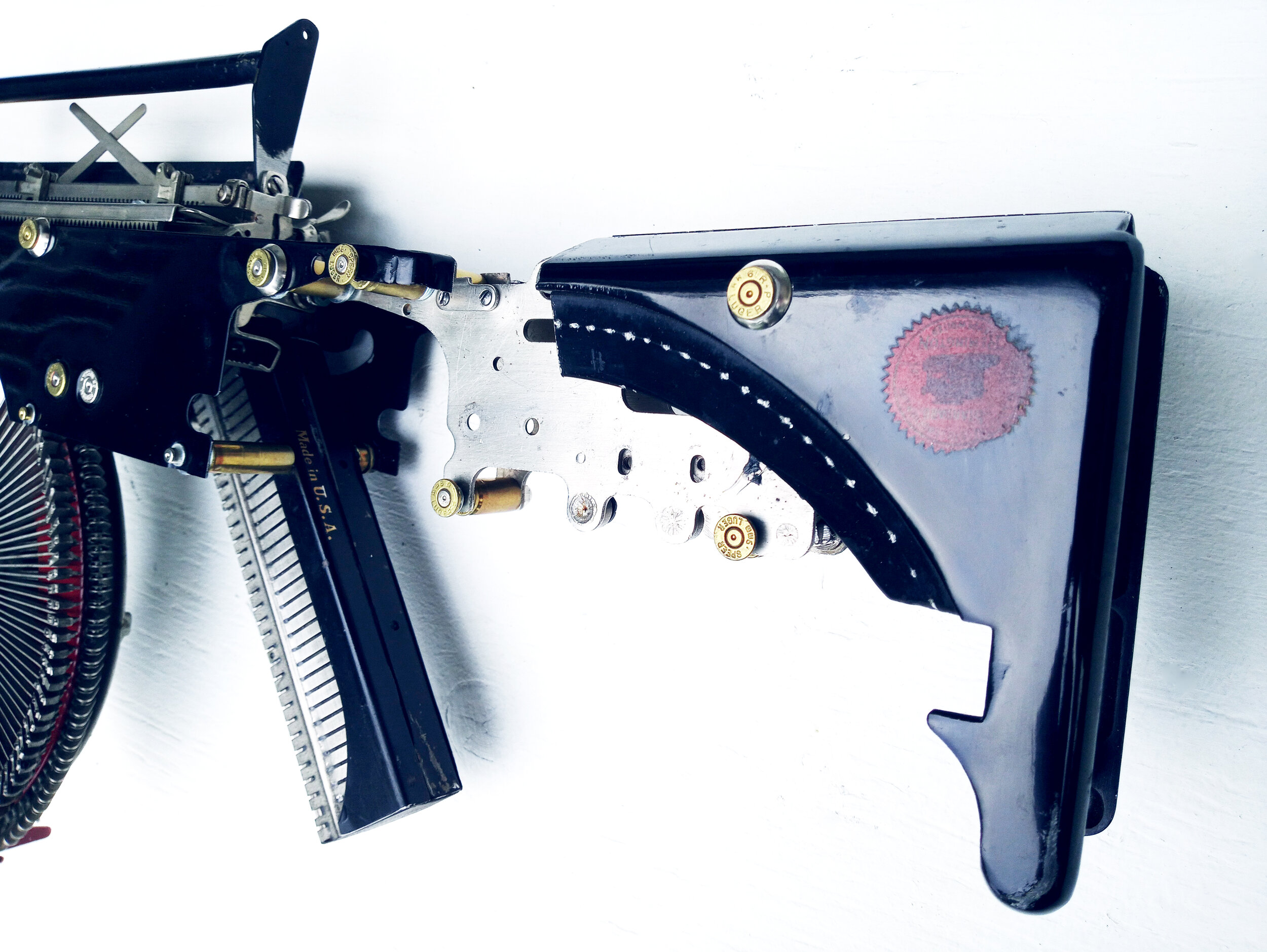  Eric Nado  - Remington Trilogy  - Typewriter MachineGun series- Aprox. Size: 11" x 30" x 3” inches. Transformed vintage Remington typewriter gun - Sculptural Wall Installation 