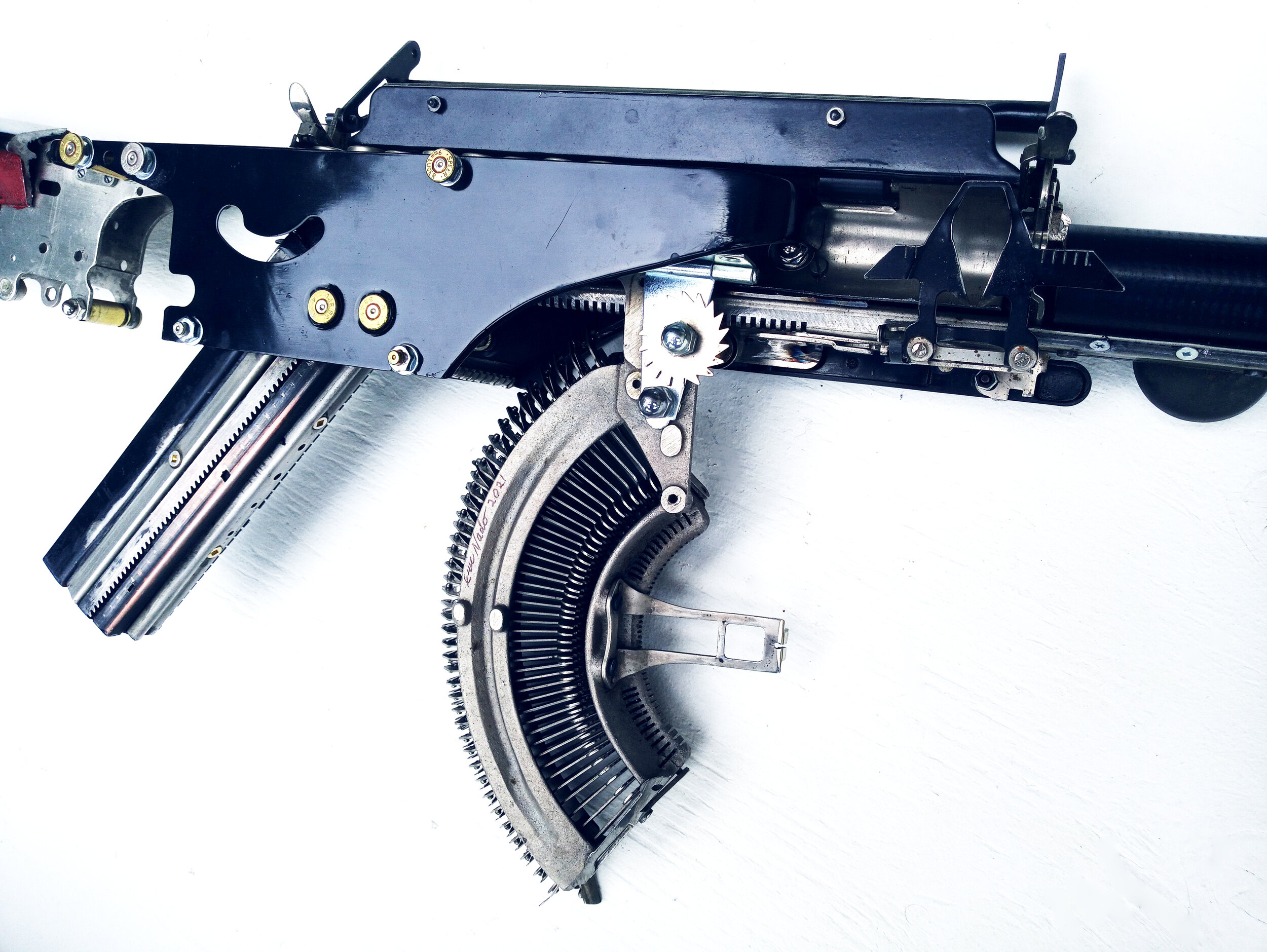  Eric Nado  - Remington Trilogy  - Typewriter MachineGun series- Aprox. Size: 11" x 30" x 3” inches. Transformed vintage Remington typewriter gun - Sculptural Wall Installation 