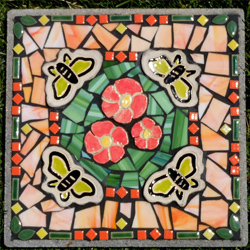 Nancy Mosely Mosaic Art Several years ago I became interested in making art for the outdoors. My vision is to place art amongst the natural beauty in nature. This series of mosaic stepping stones is created with a variety of materials that embrace an outdoor environment including a combination of tile, stained glass, glass beads and my own shaped clay tiles. Visit Artist's Website