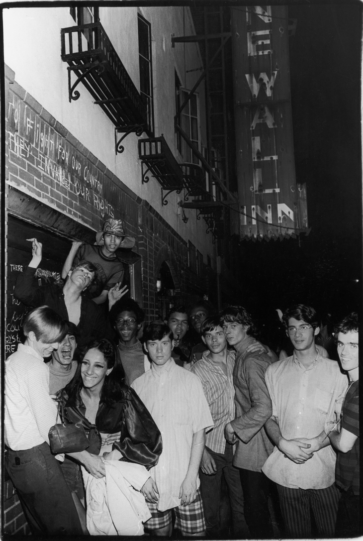  Fred McDarrah Celebration After Riots Outside Stonewall Inn, Nelly (Betsy Mae Koolo), Chris (Drag Queen Chris), Roger Davis, Michelle and Tommy Lanigan-Schmidt, June 1969, 1969 Gelatin silver print, 8 1/2 x 11 in. Collection Pavel Zoubok. Courtesy P