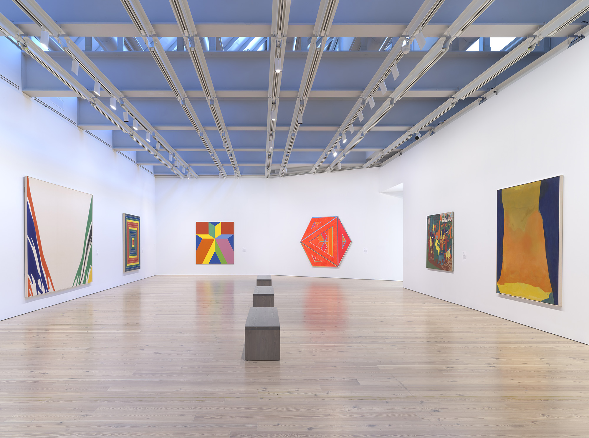  Installation view of  Spilling Over: Painting Color in the 1960s  (Whitney Museum of American Art, New York, March 29-August 2019). From left to right: Morris Louis,  Gamma Delta , 1959-60; Frank Stella,  Gran Cairo , 1962; Miriam Schapiro,  Jigsaw 