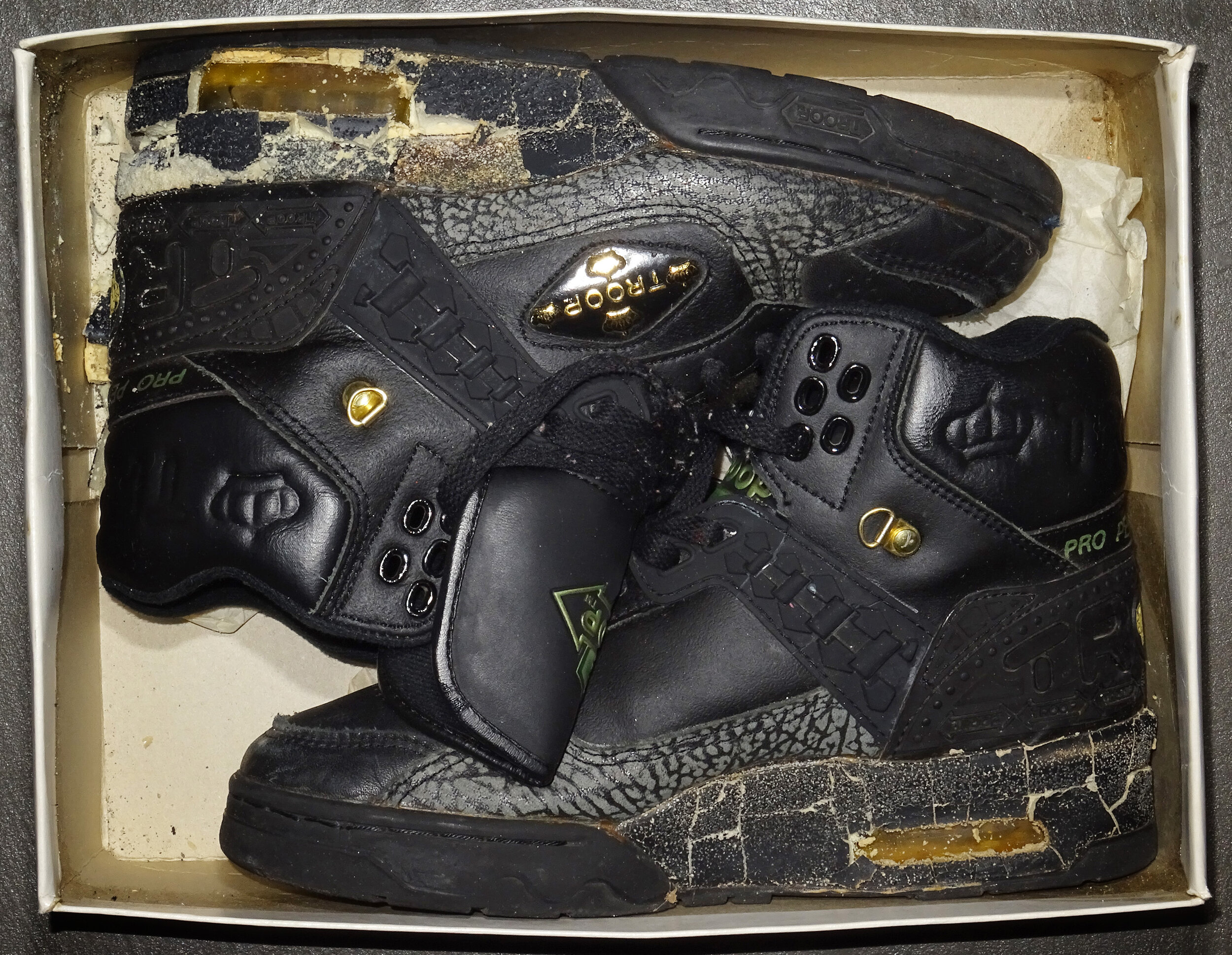  DAMAGED PAIR OF AN ORIGINAL TROOP PRO-PERFORMANCE BLACK SNEAKERS, 1985.  