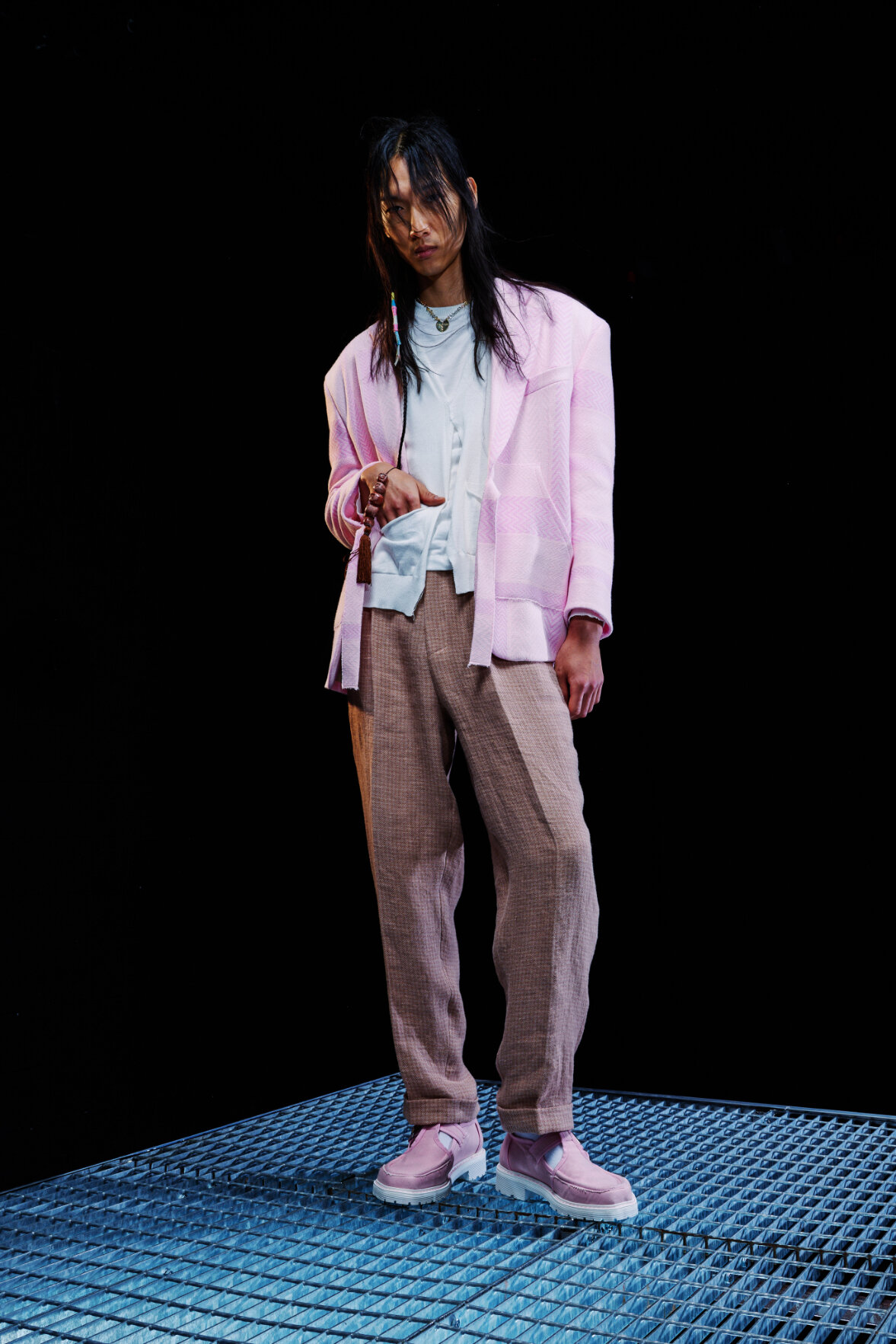  Model wears pink blazer and loafers with brown trousers for Magliano's Spring/Summer 2022 collection for Milan Fashion Week. 