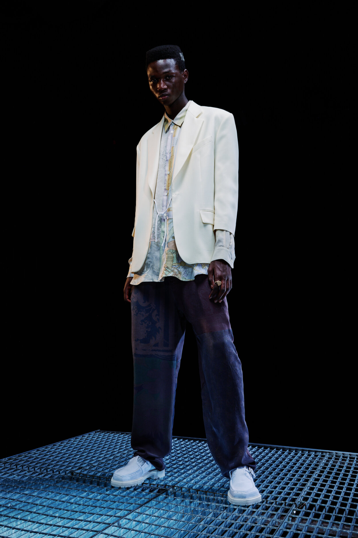  Model wears white blazer and shoes for Magliano's Spring/Summer 2022 collection for Milan Fashion Week. 