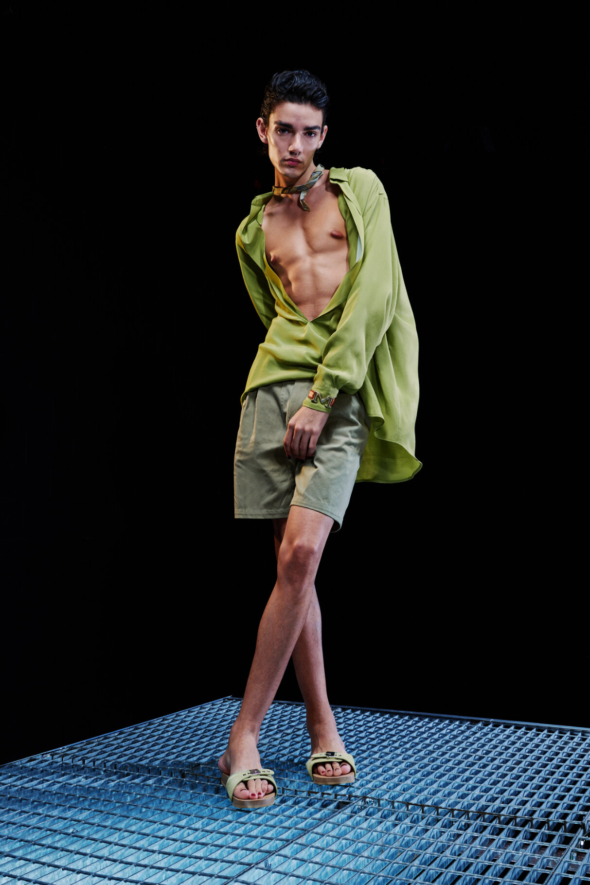  Model wears green unbuttoned top and shorts for Magliano's Spring/Summer 2022 collection for Milan Fashion Week. 
