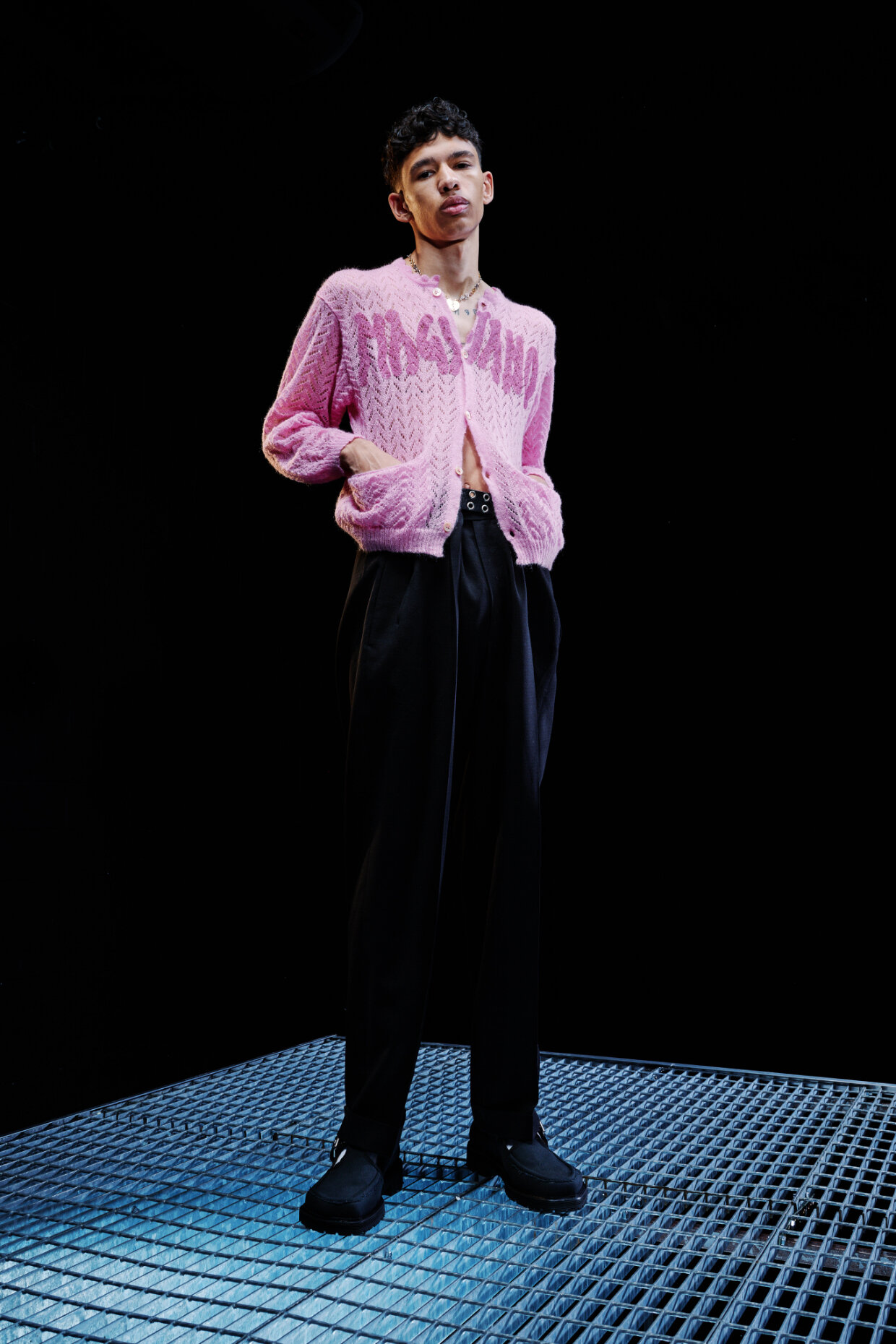  Model wears pink top and dark slacks for Magliano's Spring/Summer 2022 collection for Milan Fashion Week. 