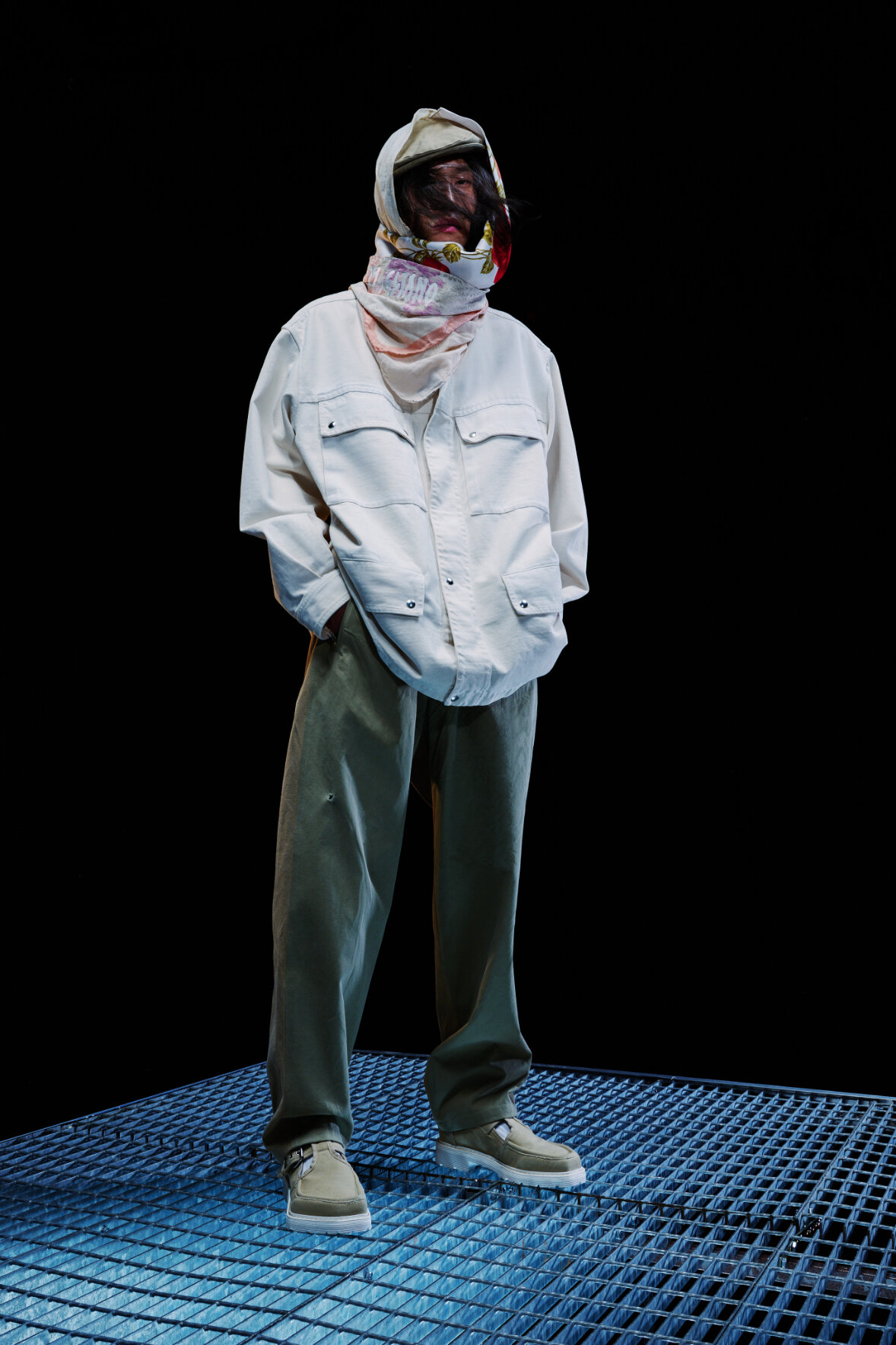  Model wears baggy white hoodie and grey pants  for Magliano's Spring/Summer 2022 collection for Milan Fashion Week. 