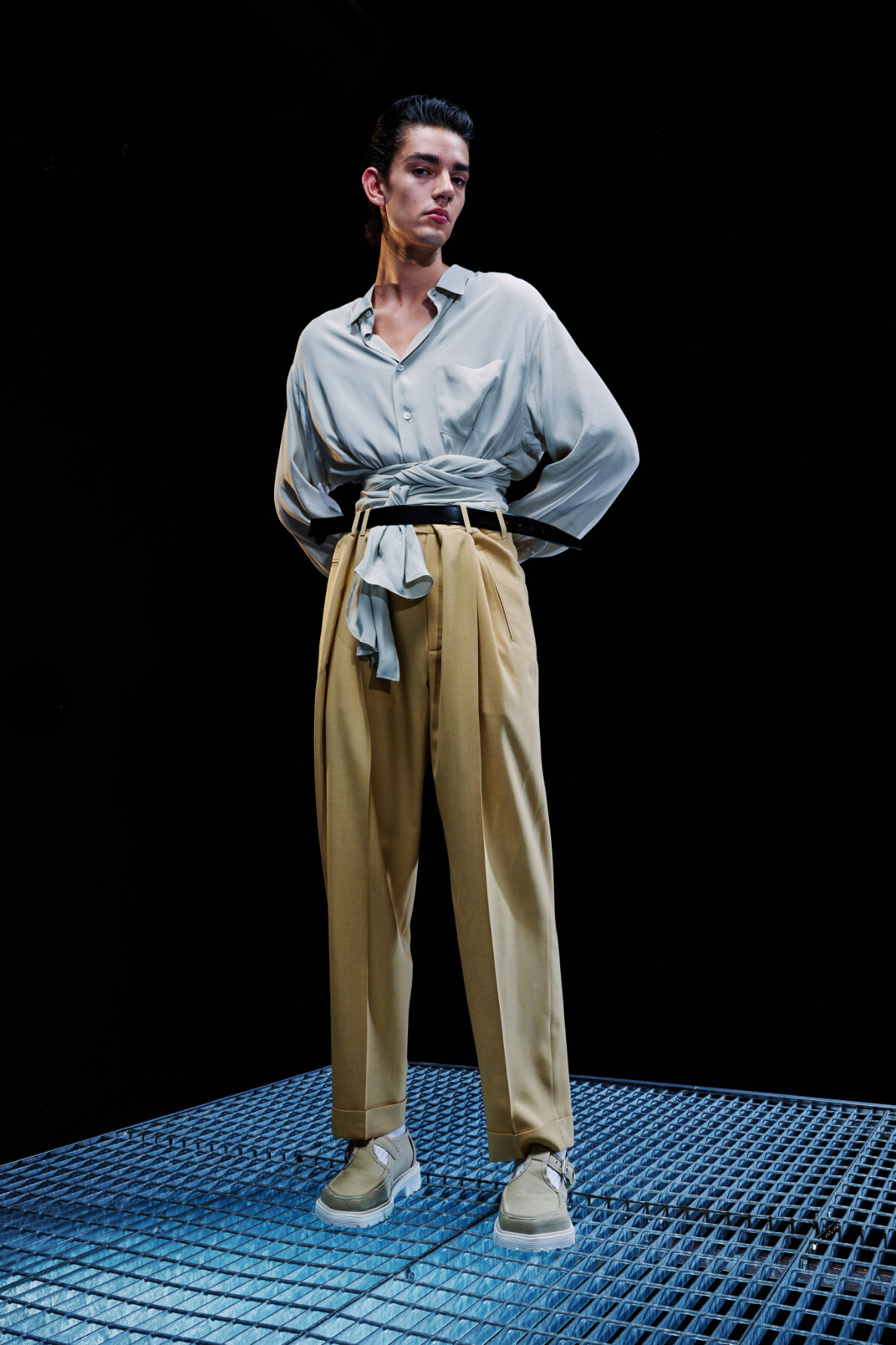  Model wears light blue shirt and tan trousers for Magliano's Spring/Summer 2022 collection for Milan Fashion Week. 