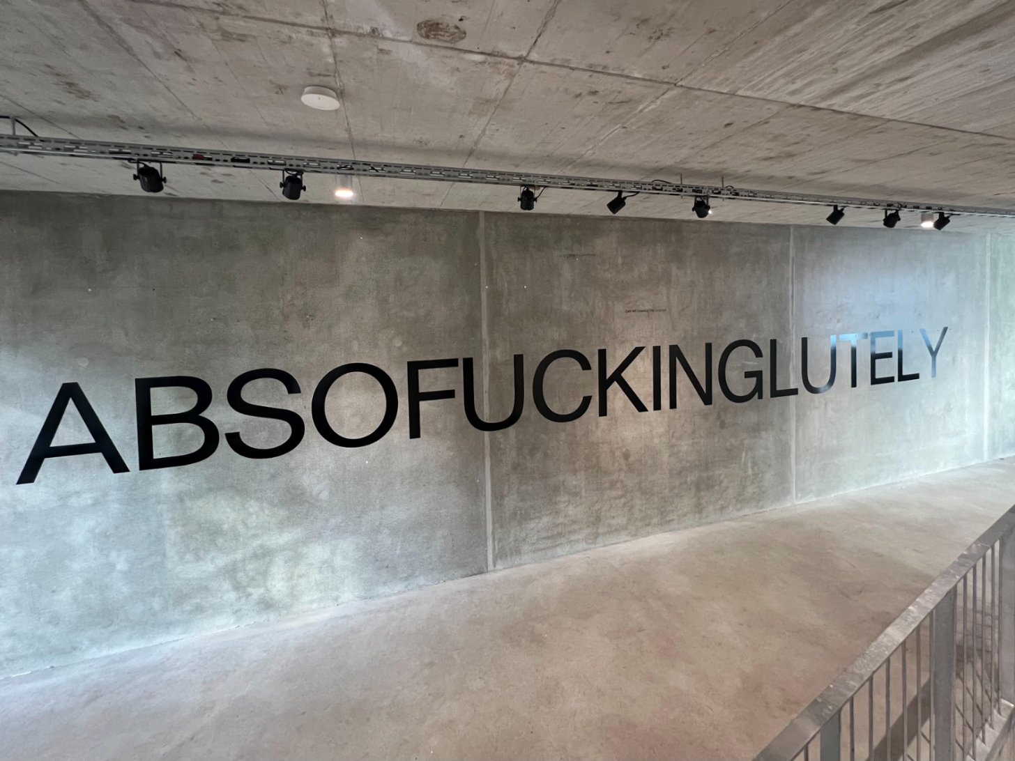   Ahmet Öğüt   Can We Change to System? Absofuckinglutely,   2022  vinyl letters directly applied on wall 800cm x 58cm / 40cm x 2cm 