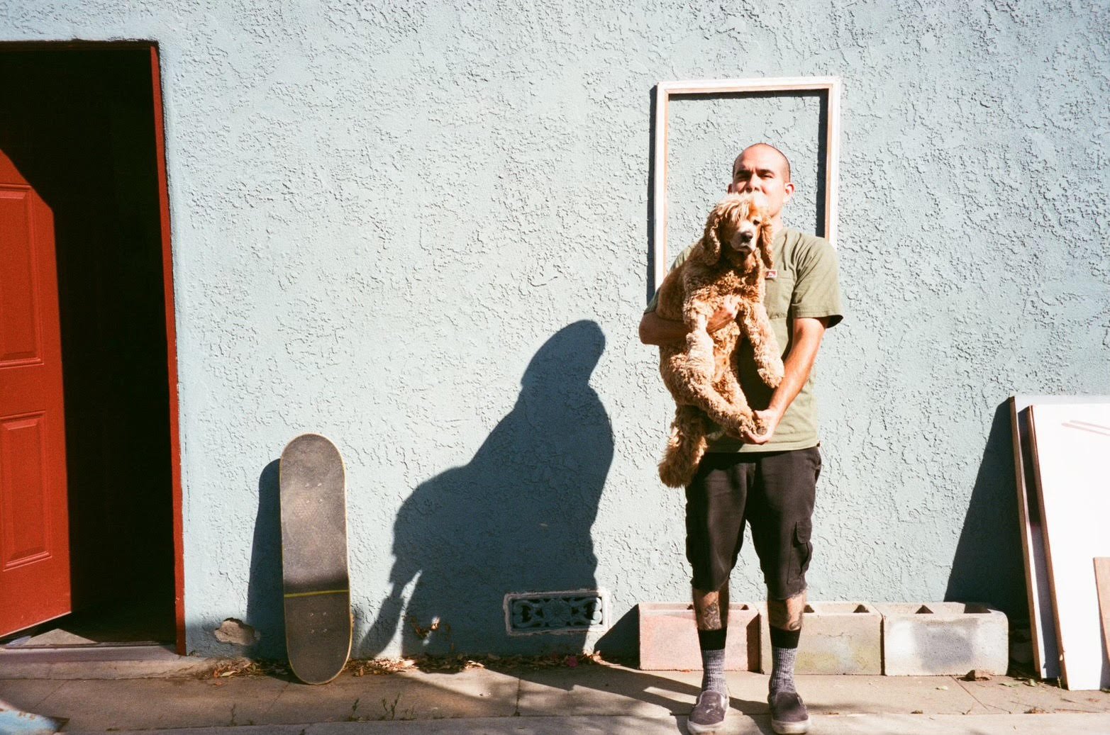 Michael Alvarez and his dog outside his LA studio. 2022. Courtesy of Sow &amp; Tailor, Los Angeles and Woaw Gallery, Hong Kong. Photography by Hannah Kirby.