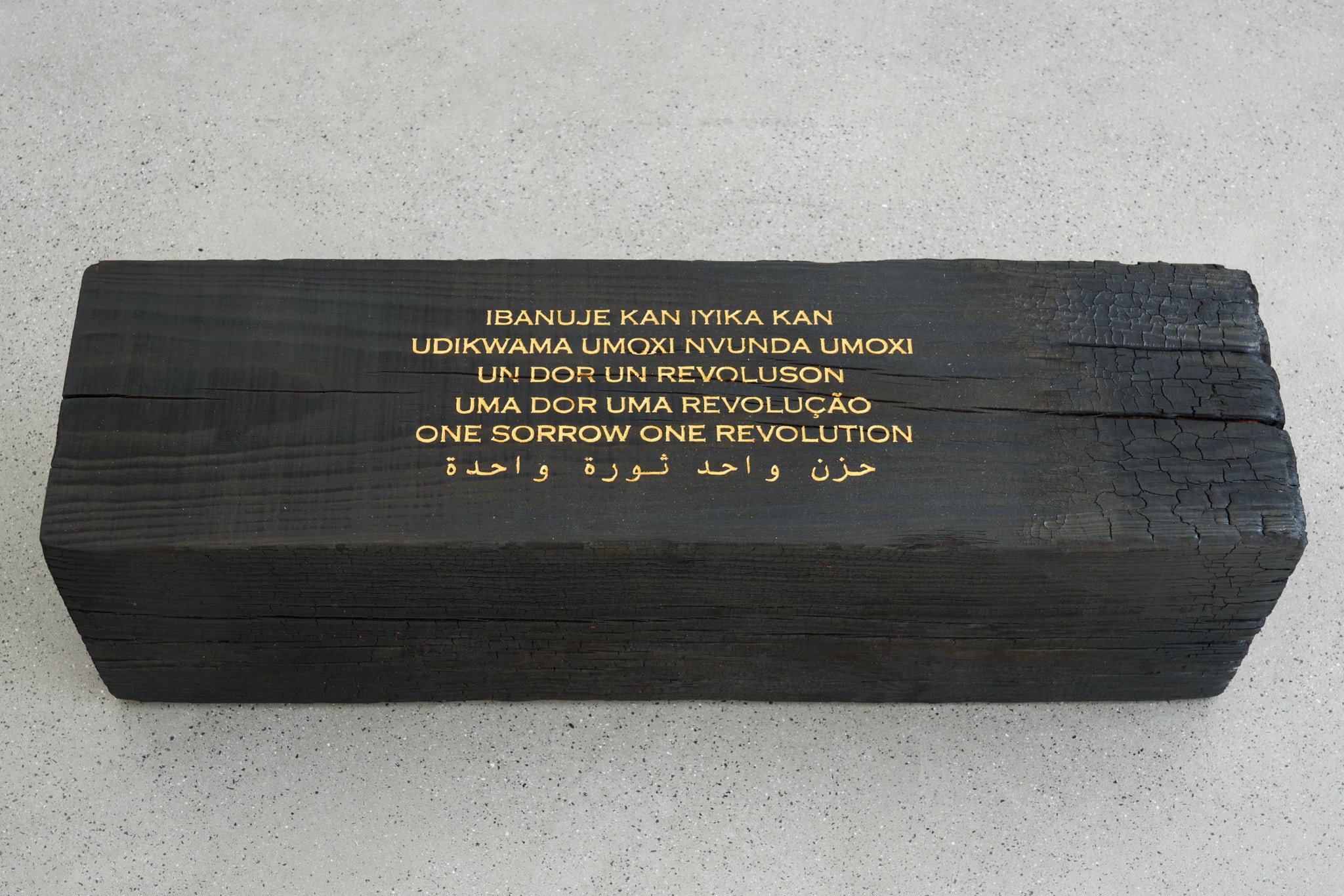  Grada Kilomba  Untitled Poem (One Sorrow, One Revolution)  (2022) Charcoaled piece, engraved poem, hand painted with gold leaf 9 1/2 x 9 1/2 x 33 7/8 in Courtesy the artist and Galerie Thomas Schulte, Berlin 