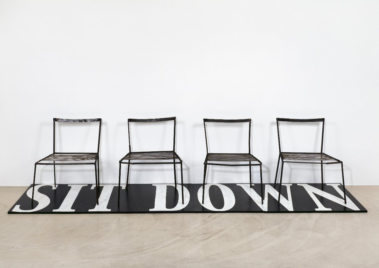  Franz West     Untitled (Sit Down)  (1996 – 2003)  4 metal chairs, wooden board and lacquer (8 parts)  Chairs: 77 x 63 x 42 cm / 30.3 x 24.8 x 16.5 inches  Board: 347 x 80 cm / 136.6 x 31.5 inches (B-FWEST-.18-0001)  © the artist  Courtesy the artis