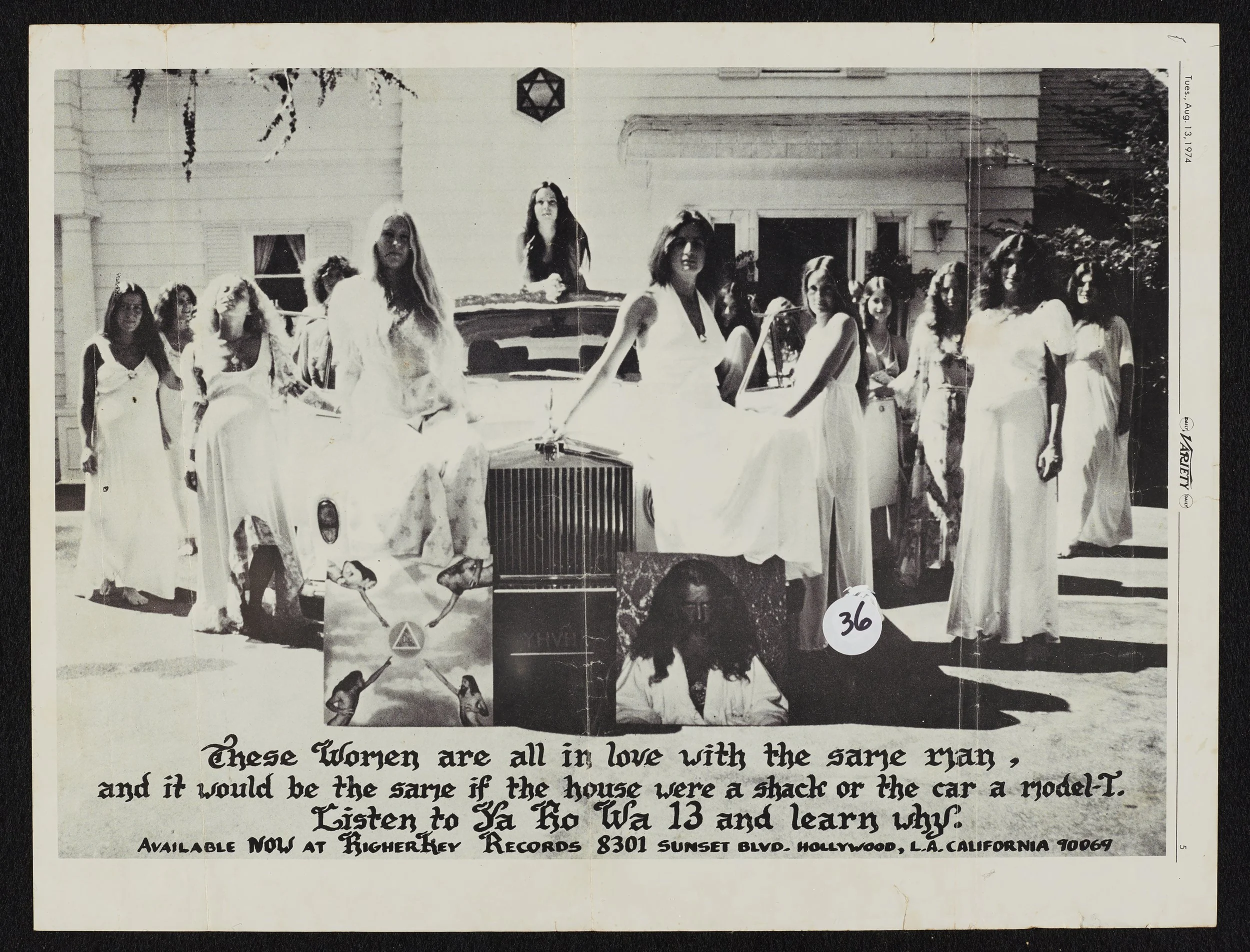 An image of several women sitting on & standing around a car