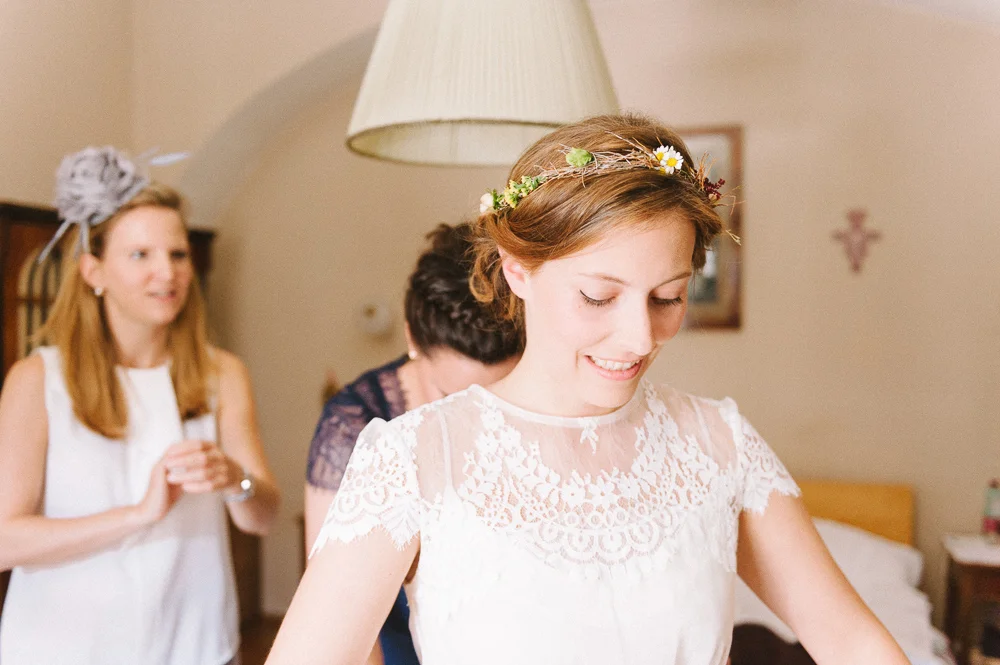 bride getting dresses in a castle