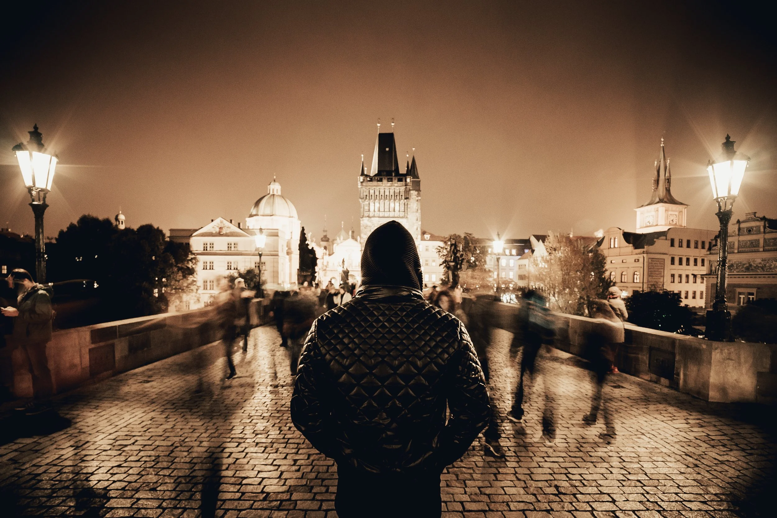 man-standing-on-pragues-charles-bridge-in-sepia-tone-picjumbo-com.jpg