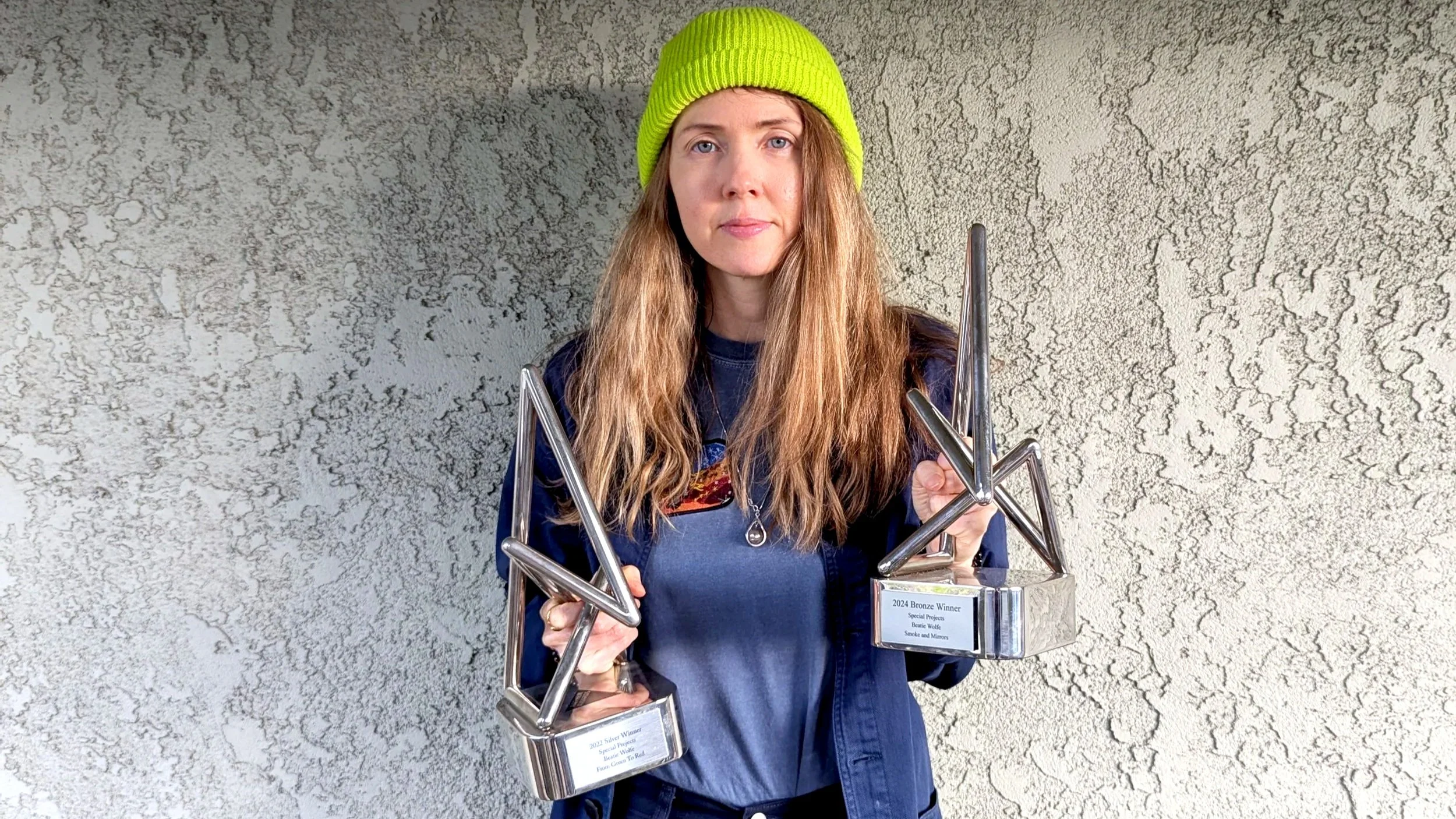 Beatie Wolfe Holding her two Anthem Awards 
