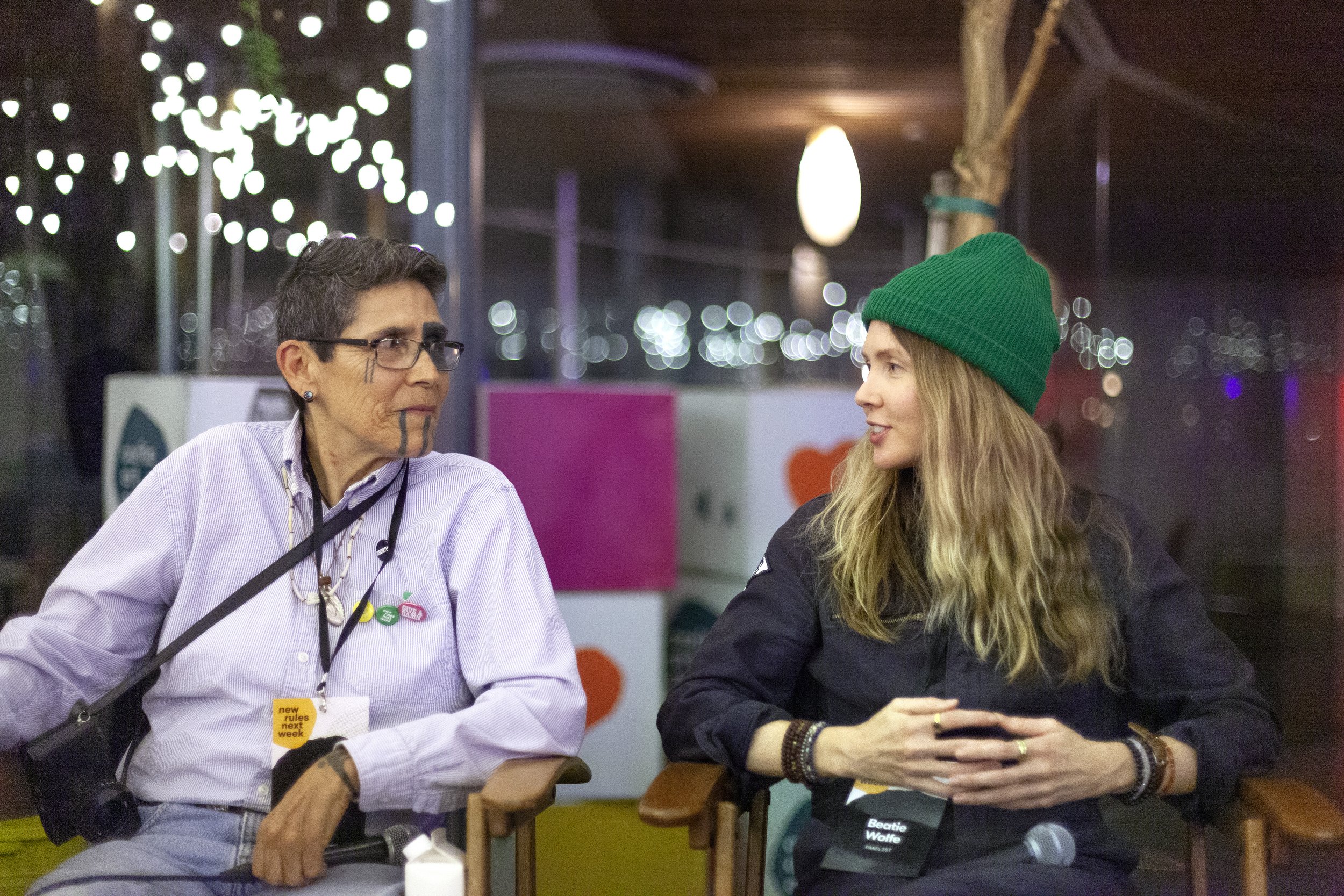 Beatie Wolfe and L. Frank talking at a Corita Kent event